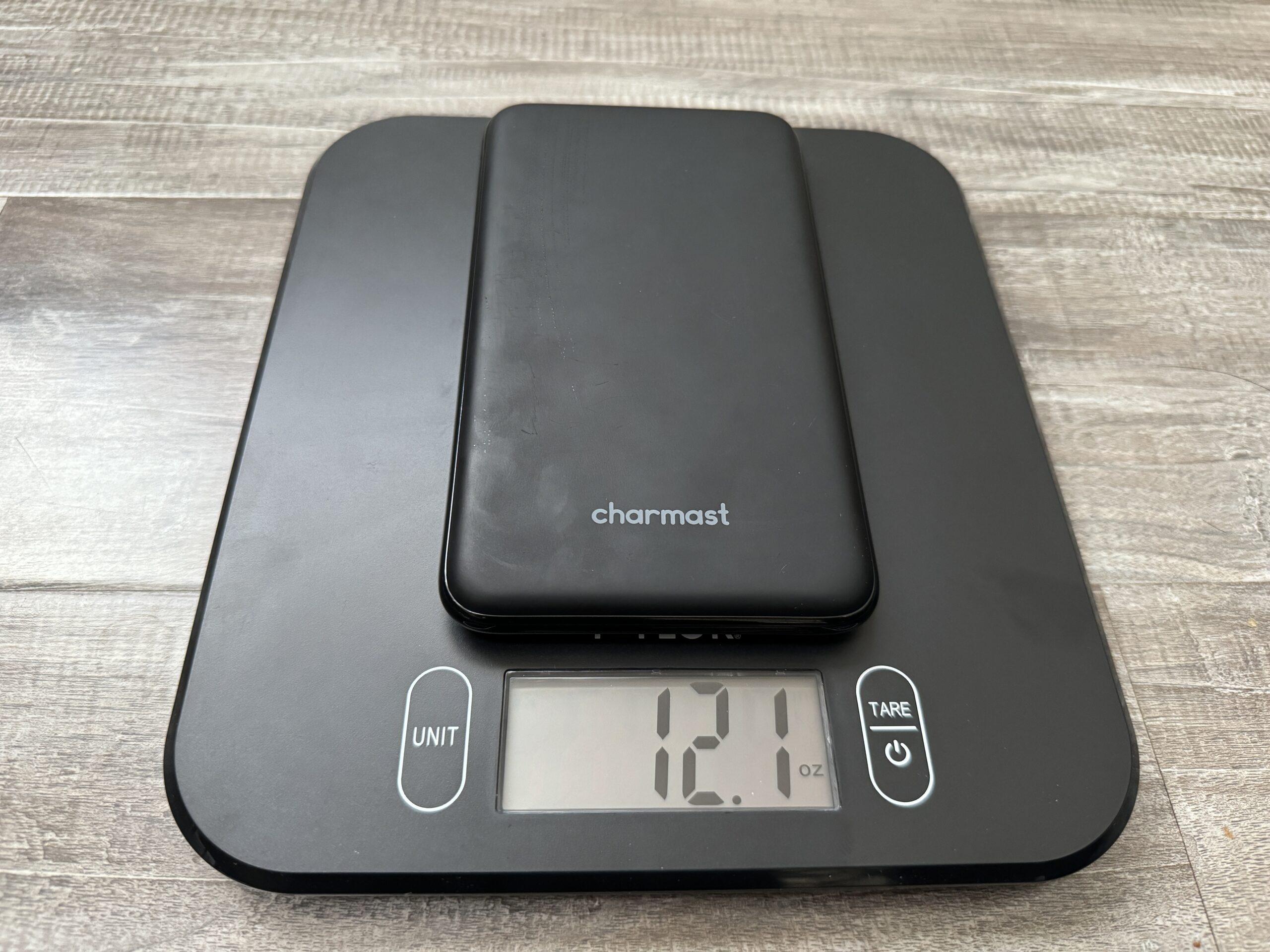 Close up of the Charmast power bank sitting on a kitchen scale.