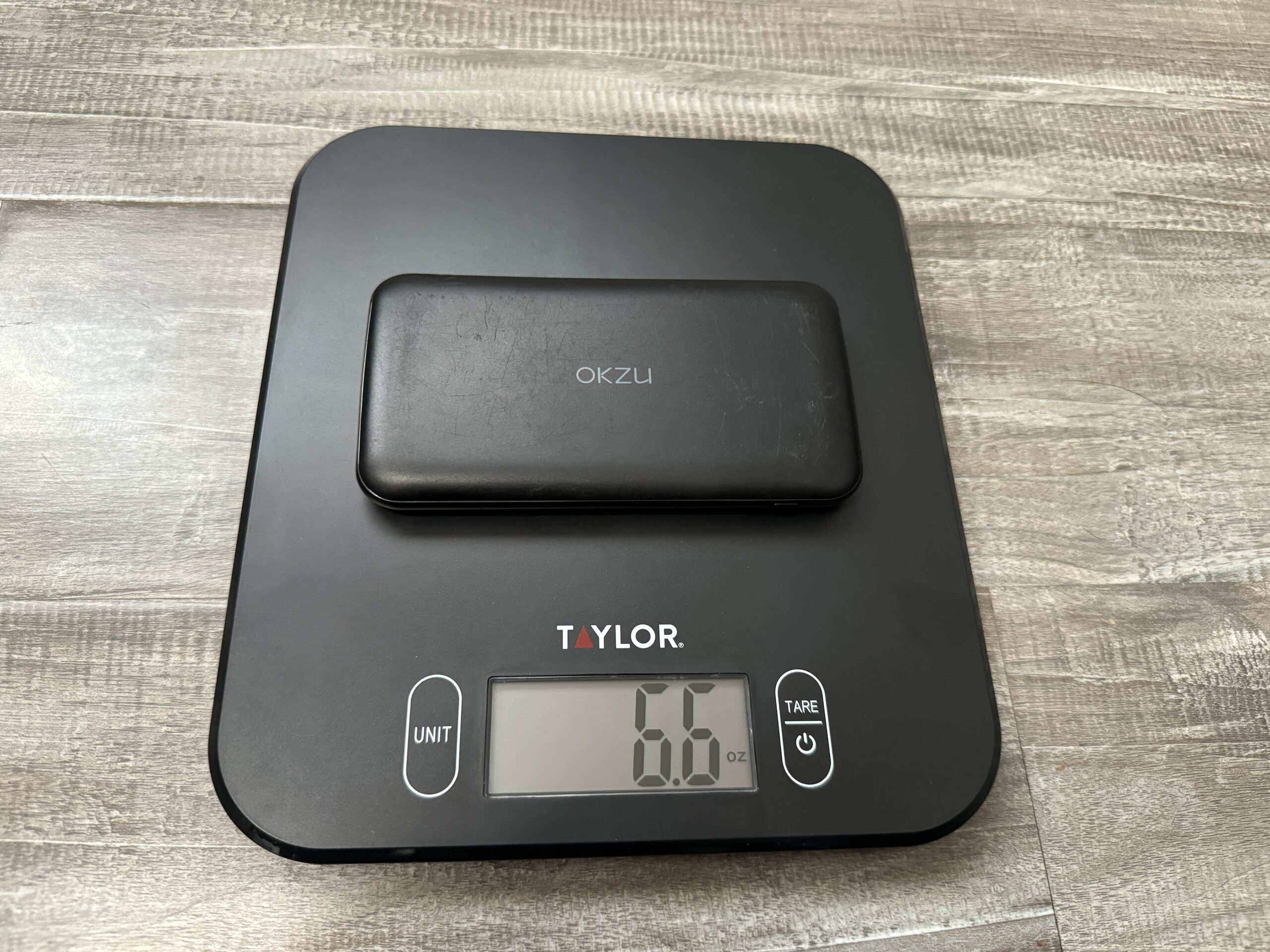 Close up of the OKZU power bank sitting on a kitchen scale.