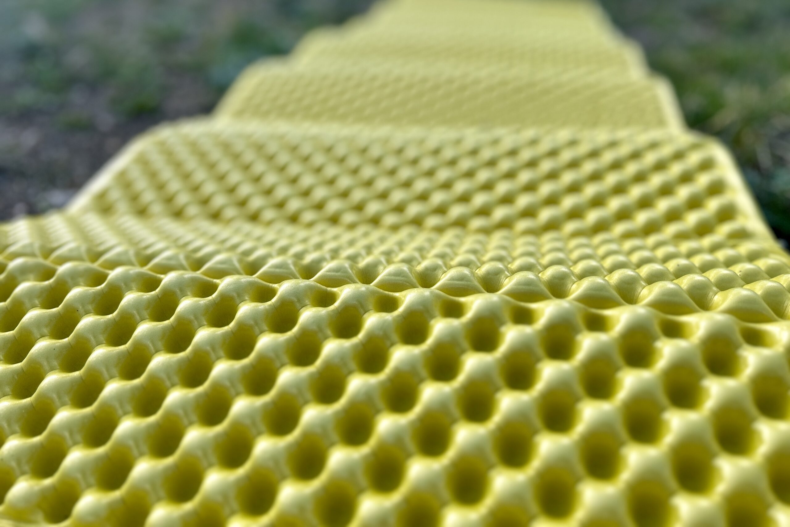 Close up of a yellow foam mat showing its bumpy texture.