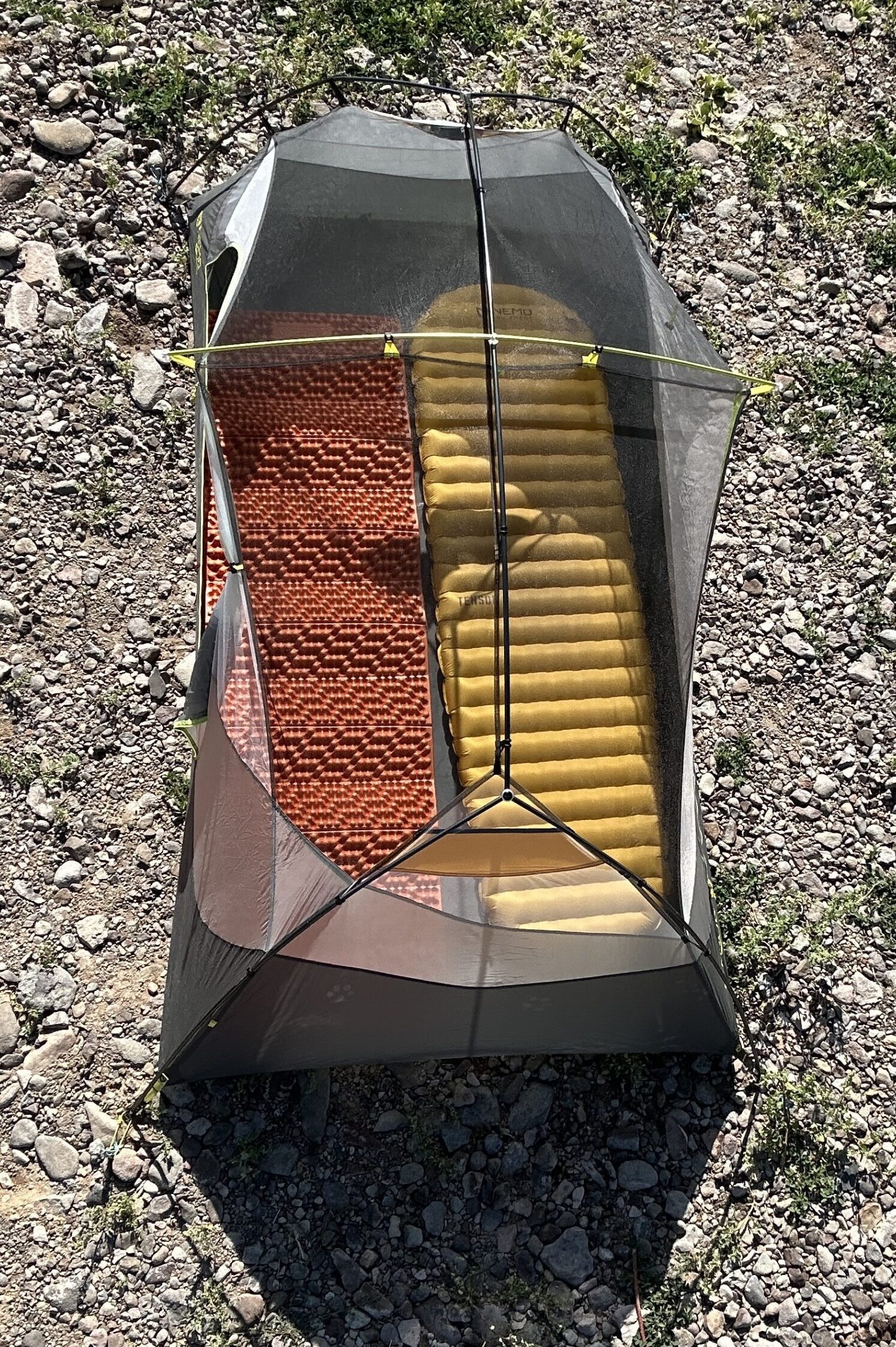 Two sleeping pads in a tent with no rainfly from high above.