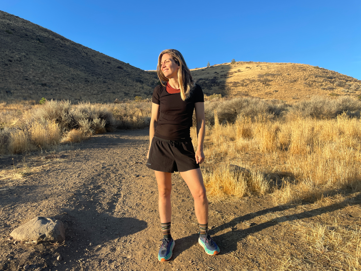 a women stopped on a trail in the desert wearing light hiking shorts in black 