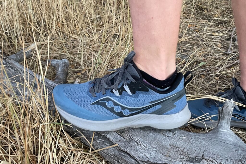 a side view of a hiker's foot wearing the saucony peregrine 14 hiking shoe