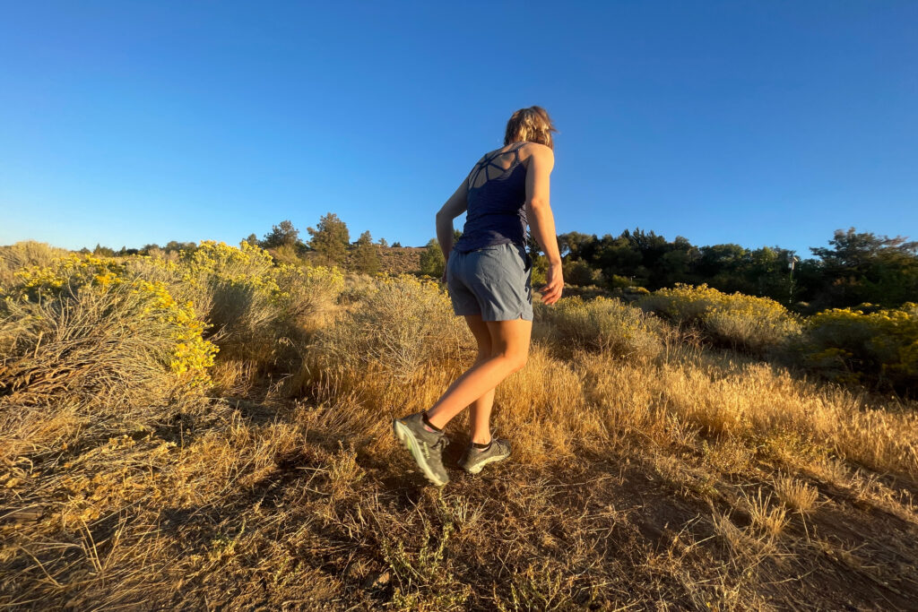 a woman walking in the high desert brush