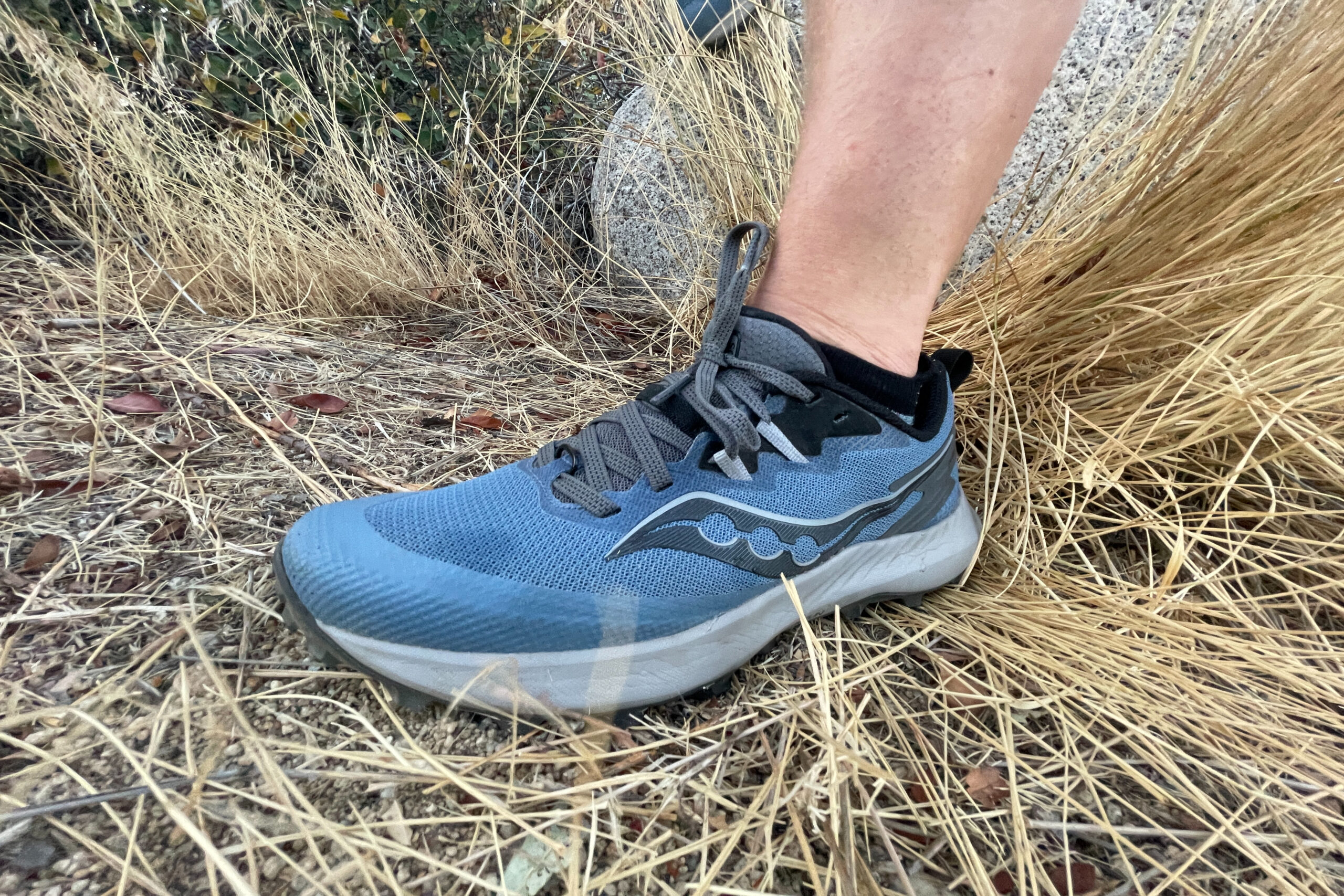 a close up of a lightweight trail running shoe by Saucony