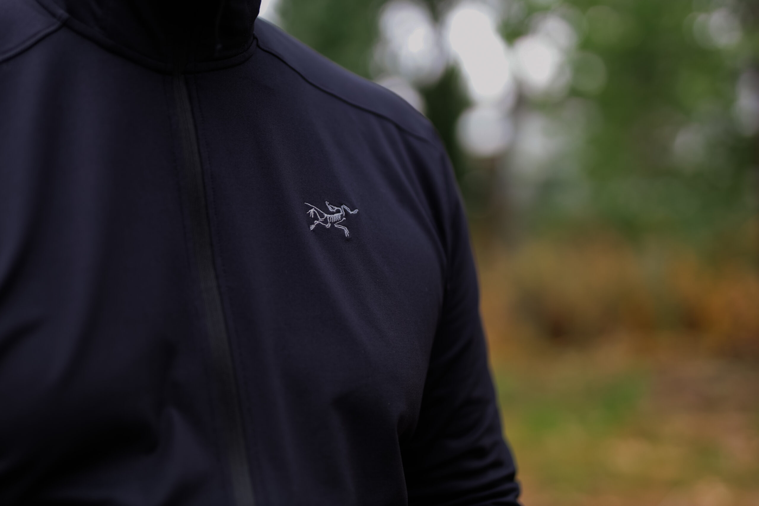 Close up of the Arc’teryx logo on the chest of a fleece.