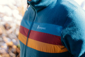 The Cotopaxi logo on the front of a fleece.