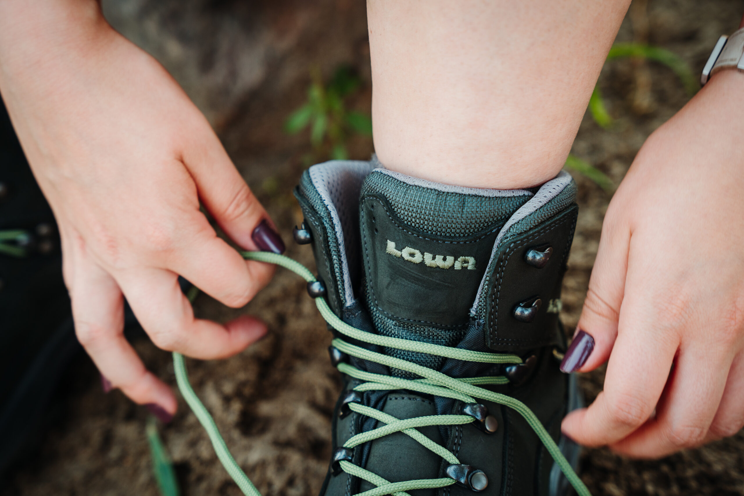 Hiker tying her Lowa Renegade GTX Women's Hiking Boots