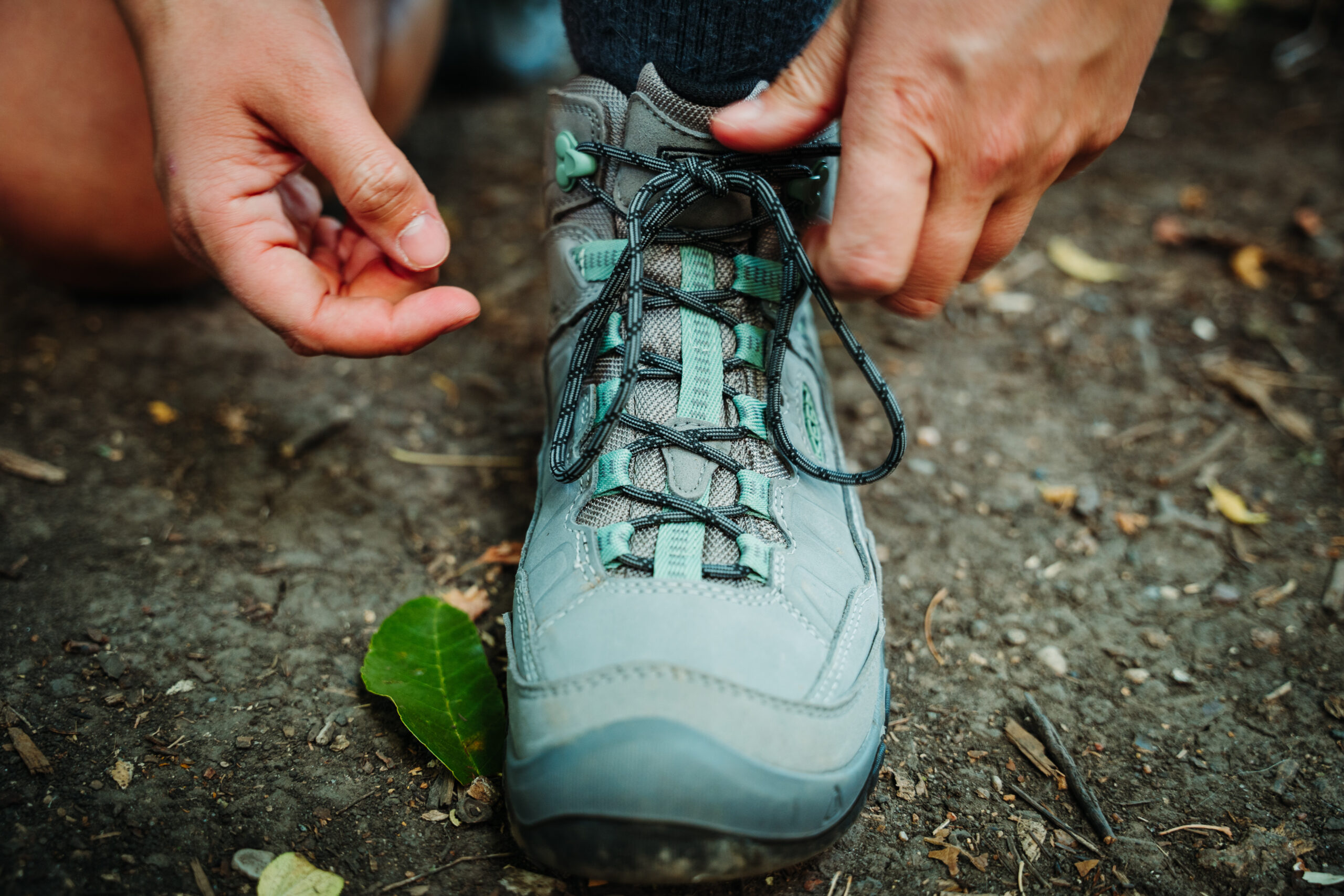 Hiker stopped on a path to adjust her Women’s KEEN Targhee IV WP