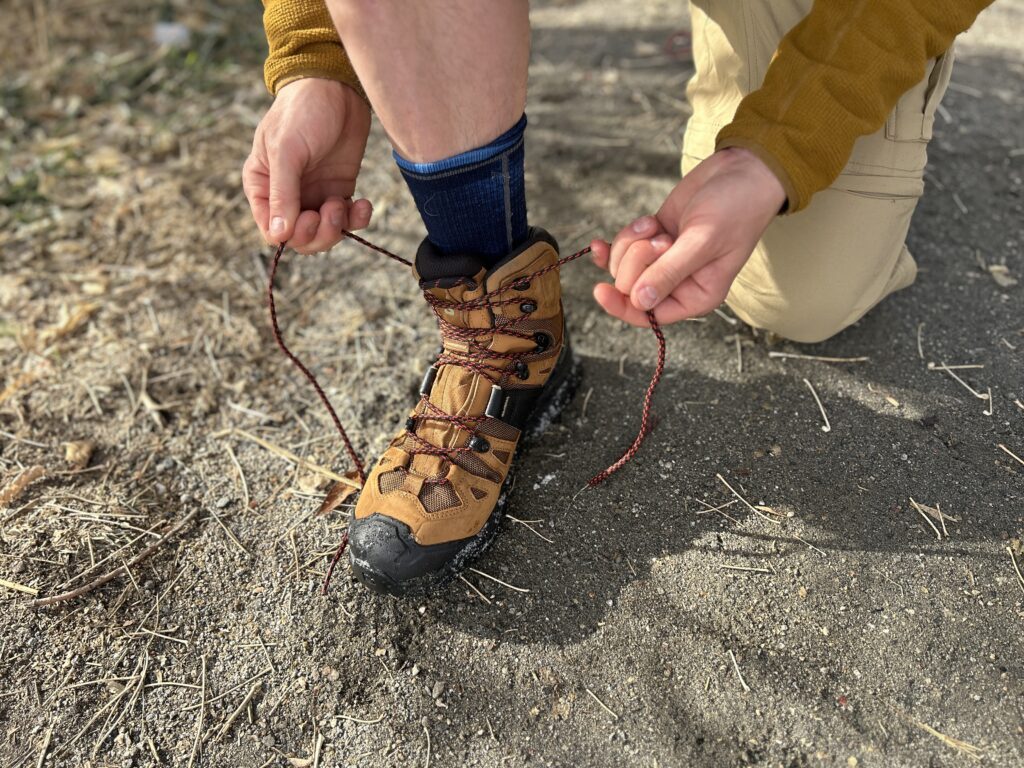 Close up of a person tying their boots.