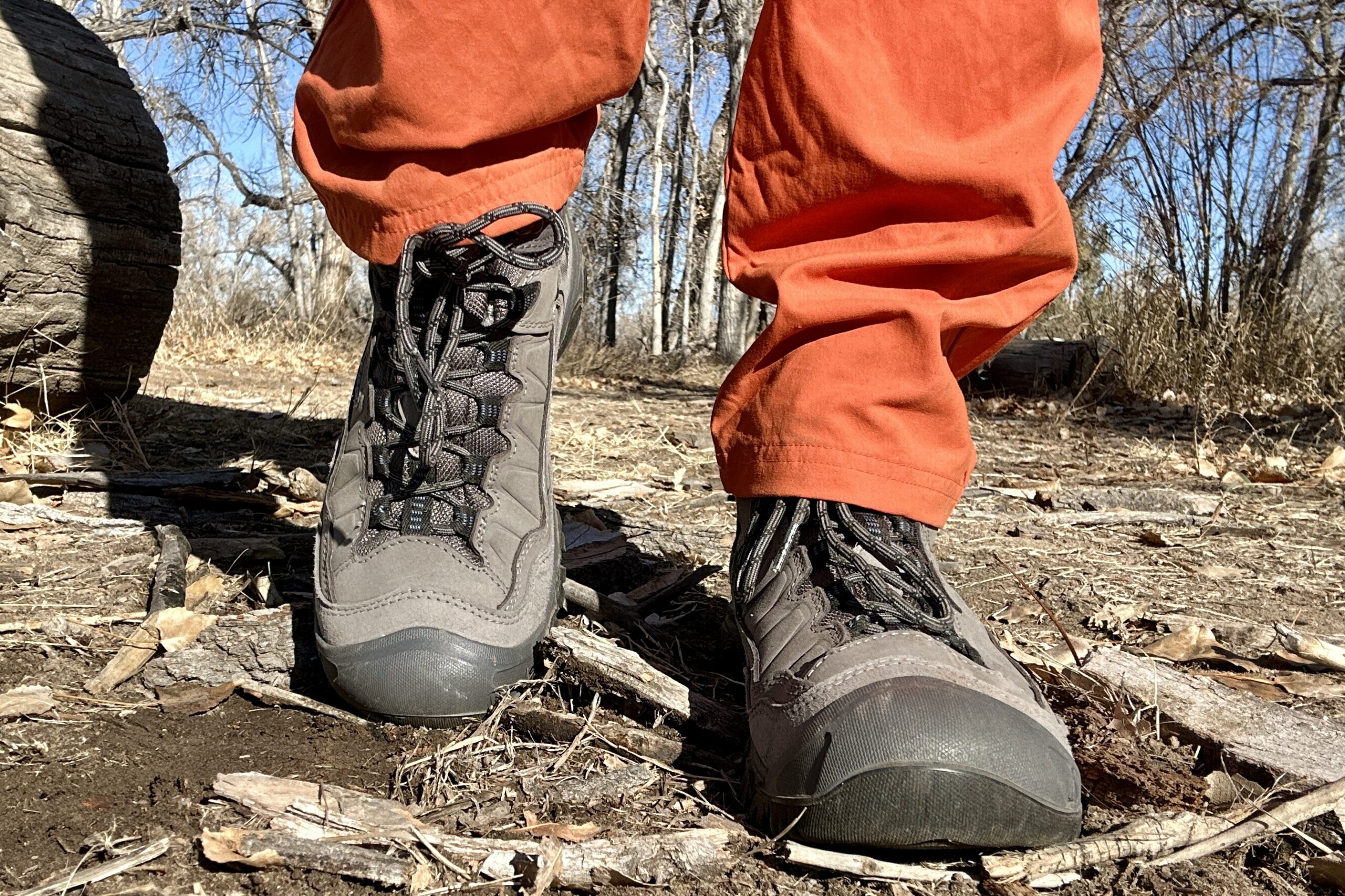 Close up image from knees down of hiking boots from the front.