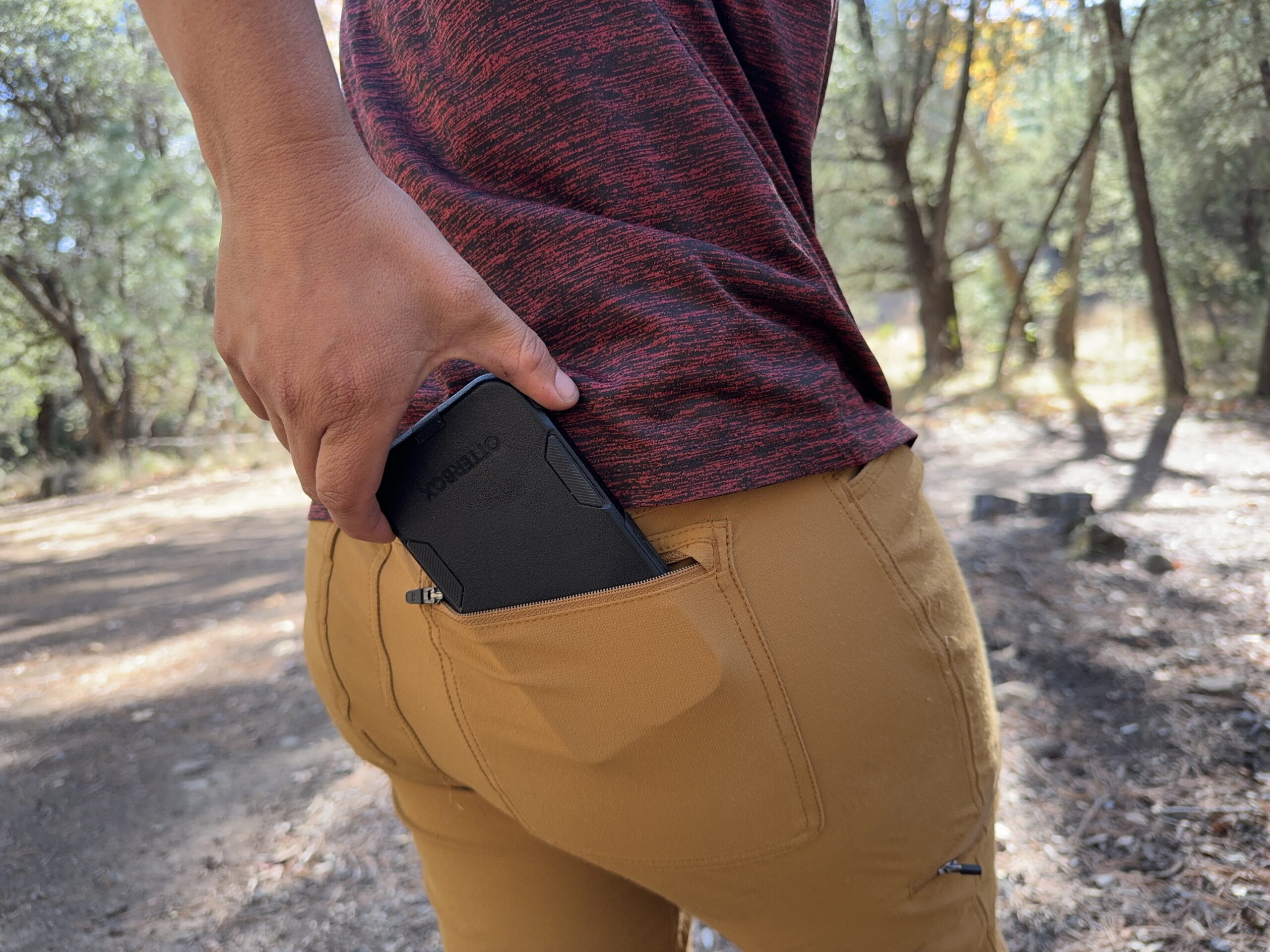 Close up of a phone being placed in the back pocket of the Ferrosi pants.