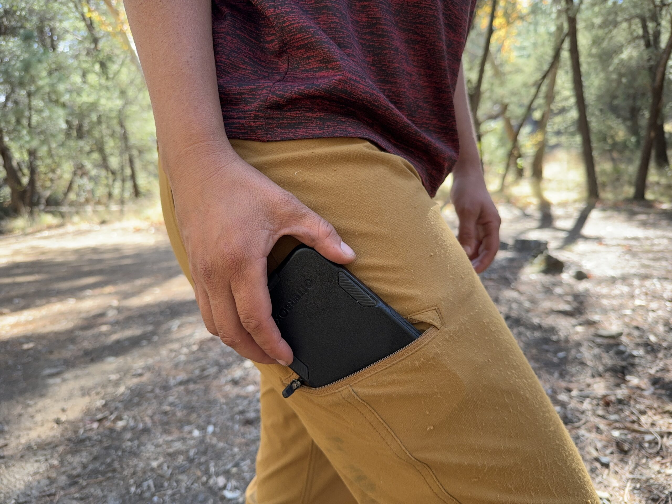 Close up of a phone being placed in the leg pocket of the Ferrosi pants.