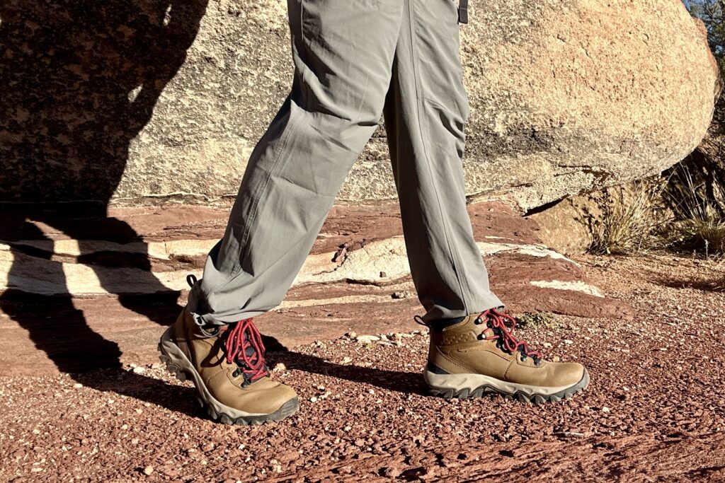 Close up of a man walking in hiking boots, image from knees down.