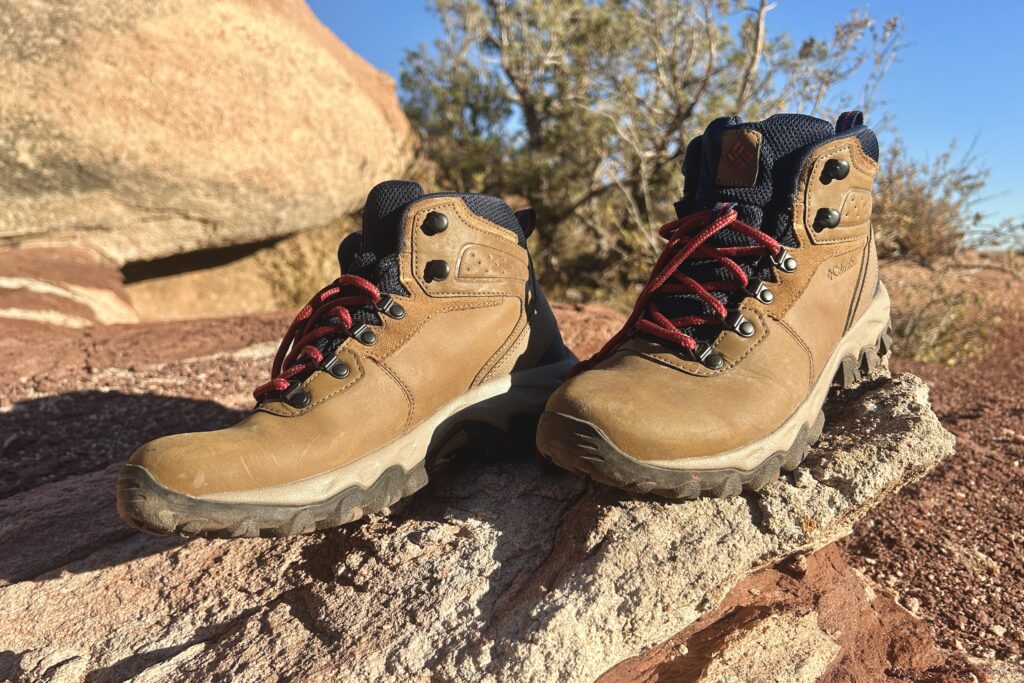 Close up of a pair of hiking boots on a rock.