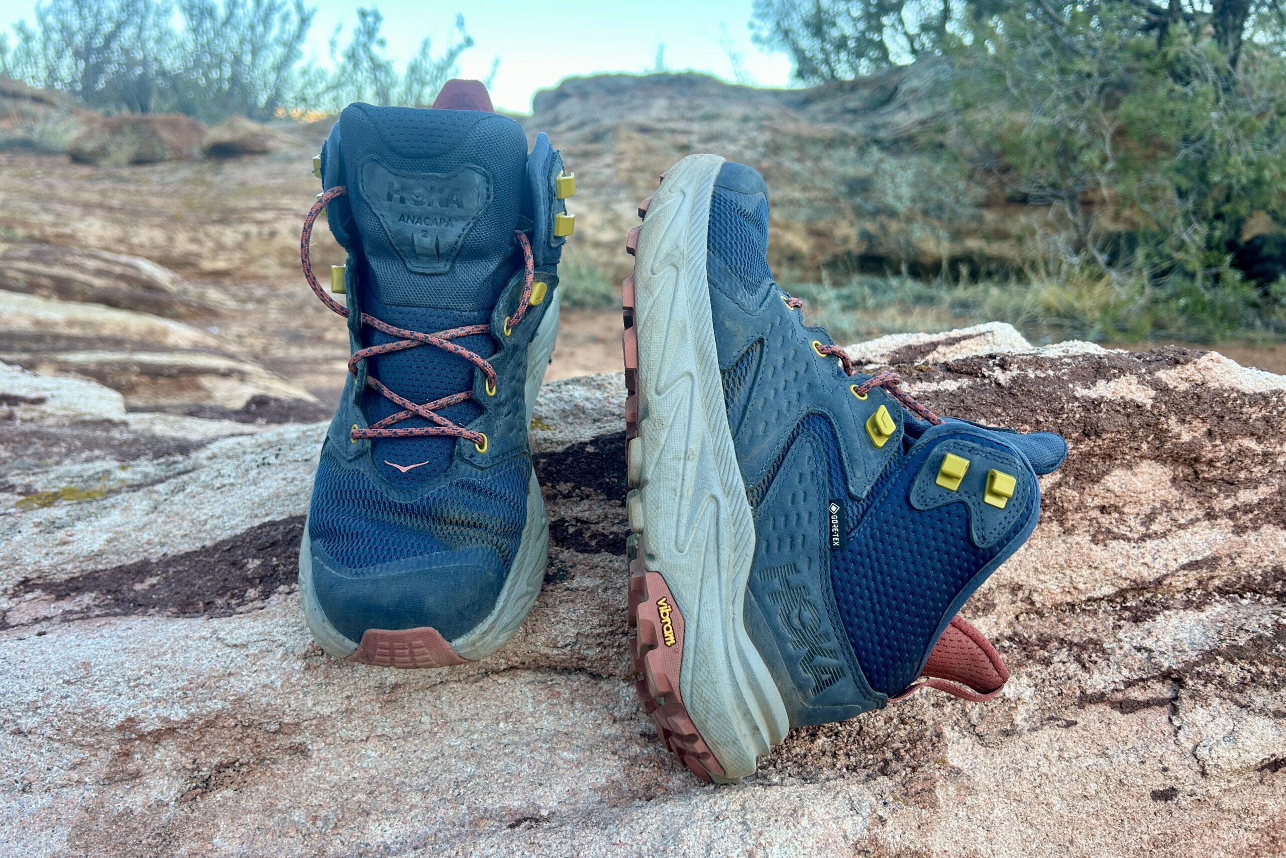 Close up of a pair of hiking boots posed on a rock.