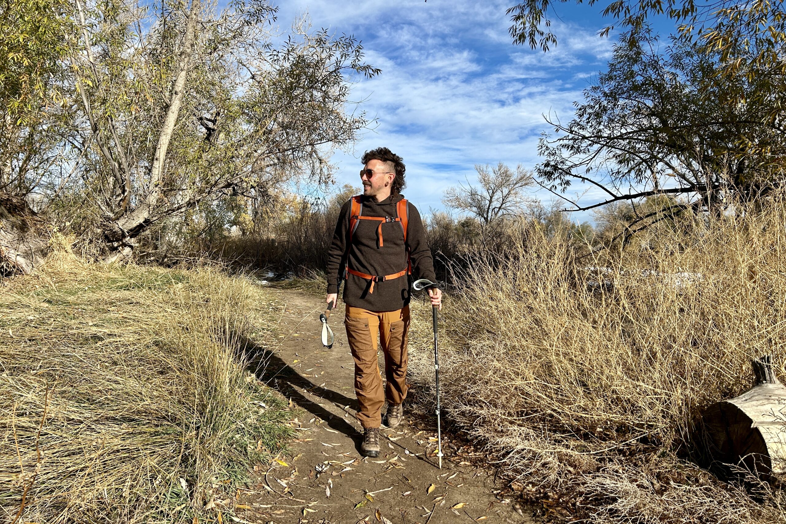 A man hikes in a wilderness area in fall.