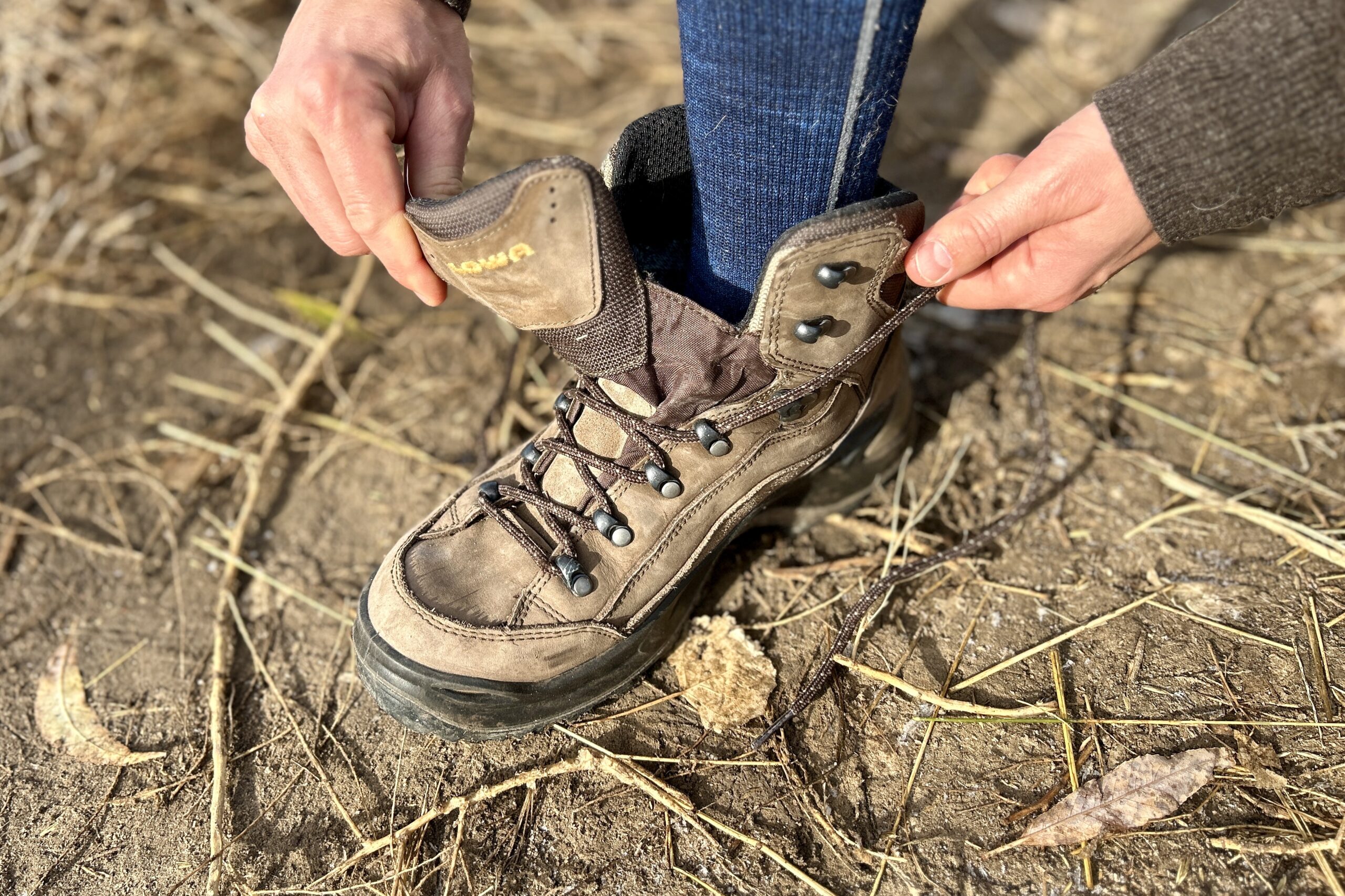 Close up of a person tying their boots.