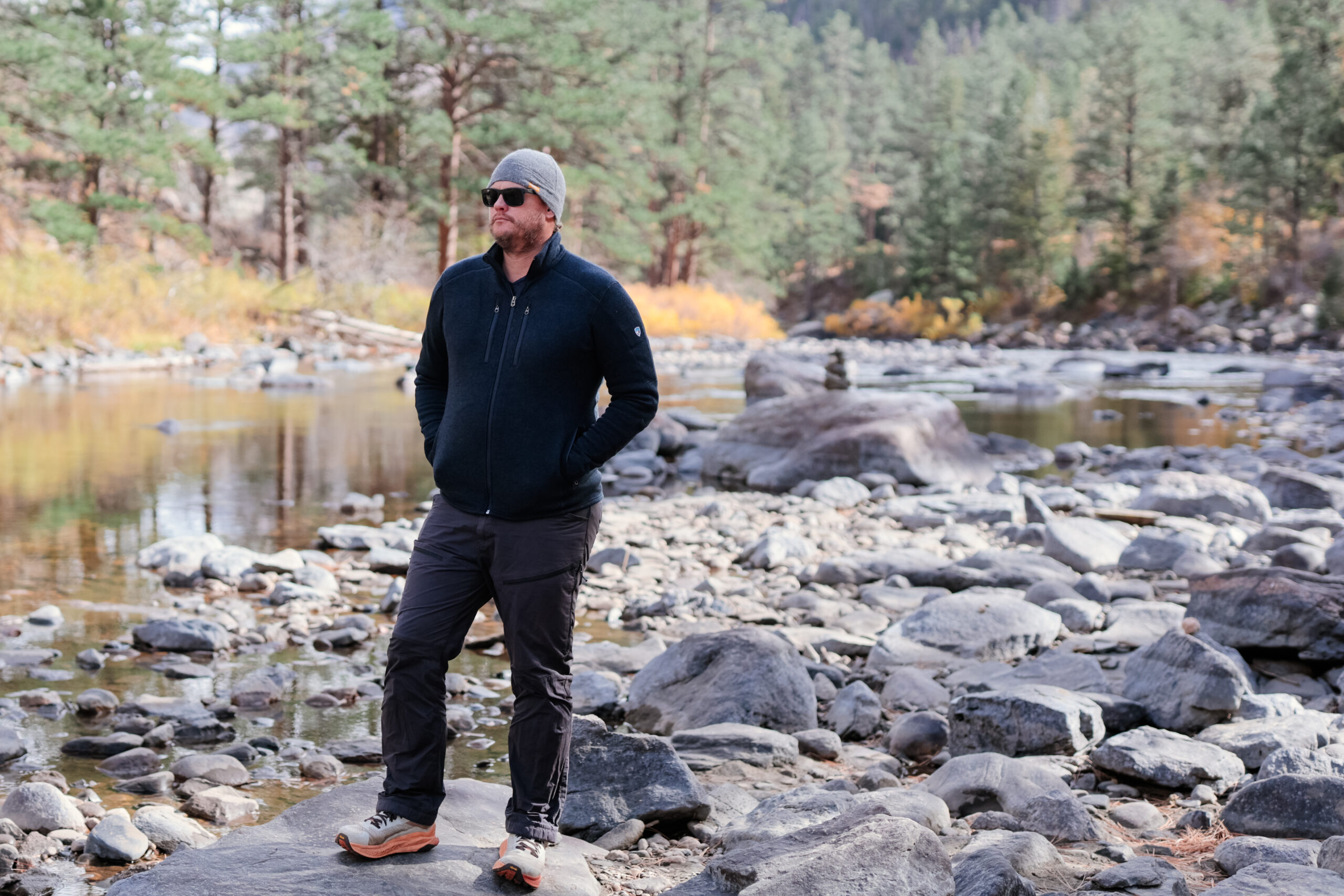 Man stands by a river.