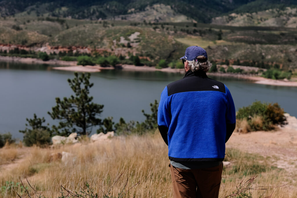 The back of a man in a blue fleece.