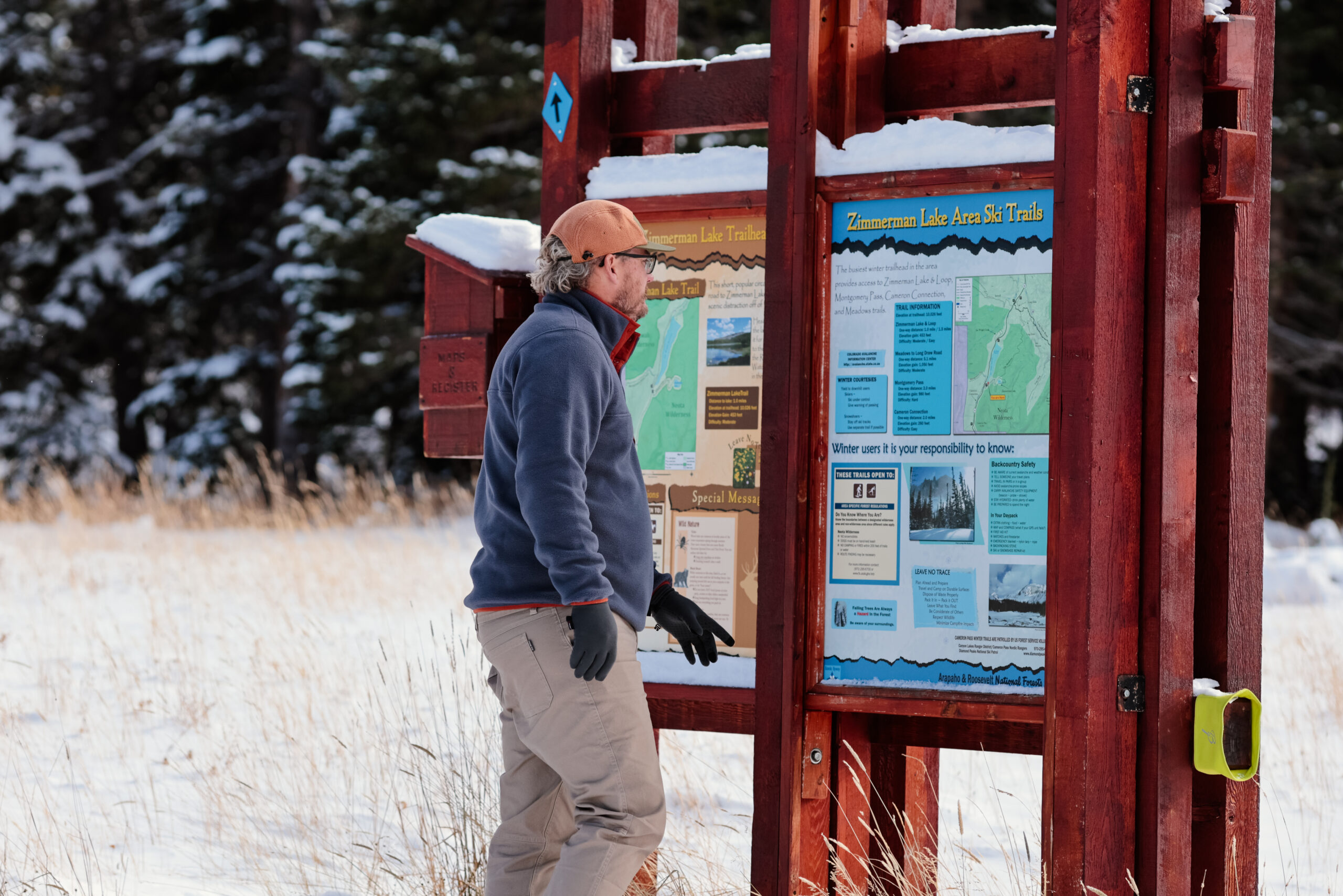 Man looking at a trail sign.