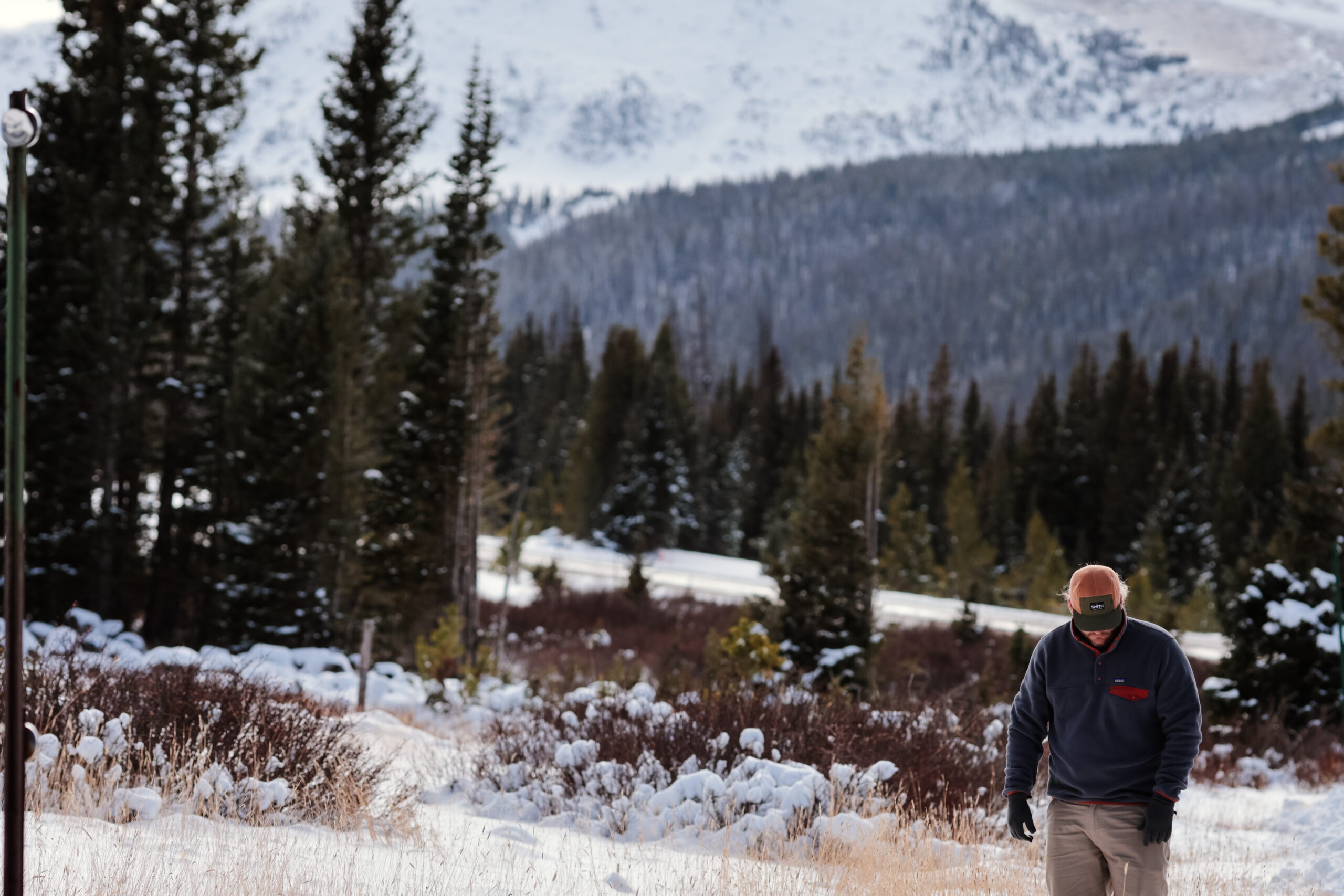 Man walking on a snowy trail.