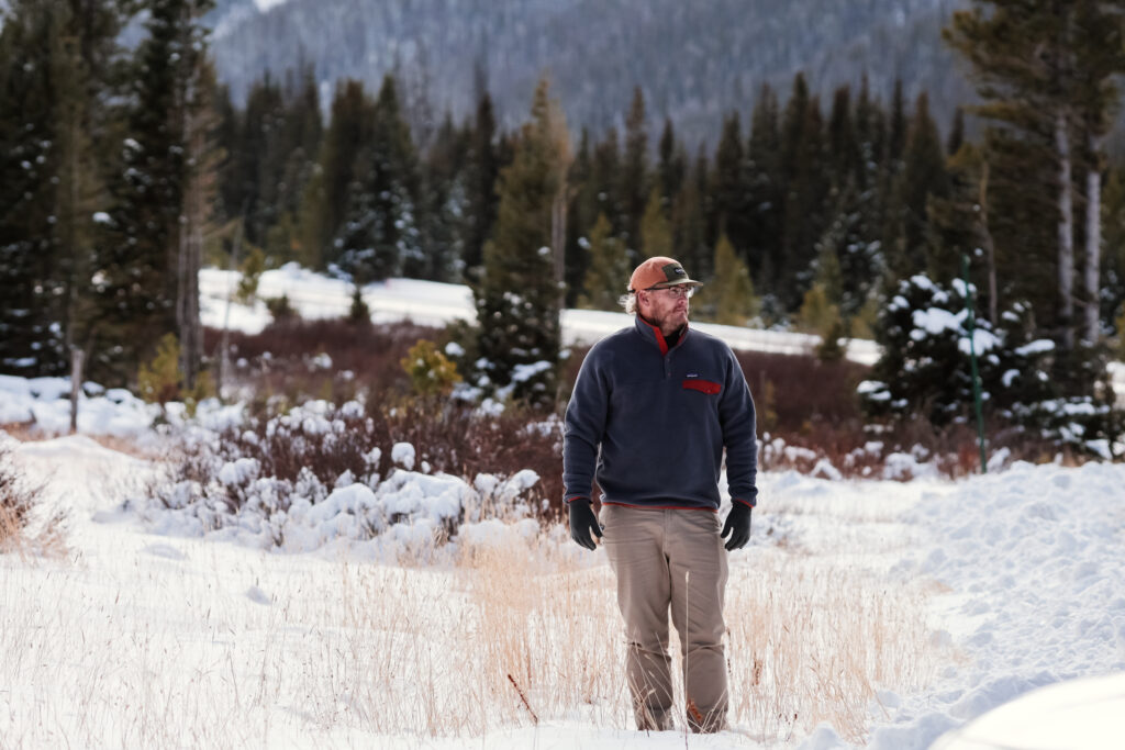 Man standing in a snowy field.