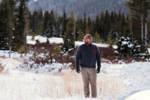 Man standing in a snowy field.