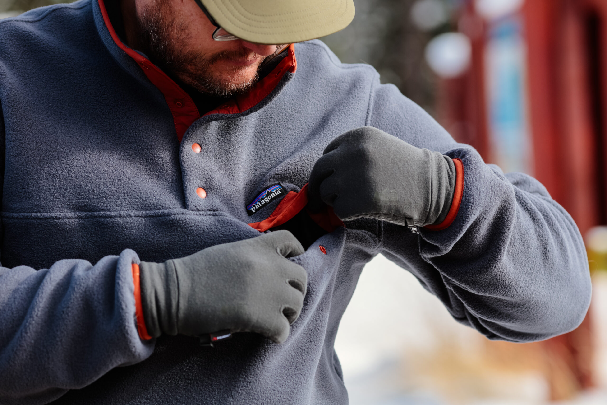 Man opens a fleece chest pocket.