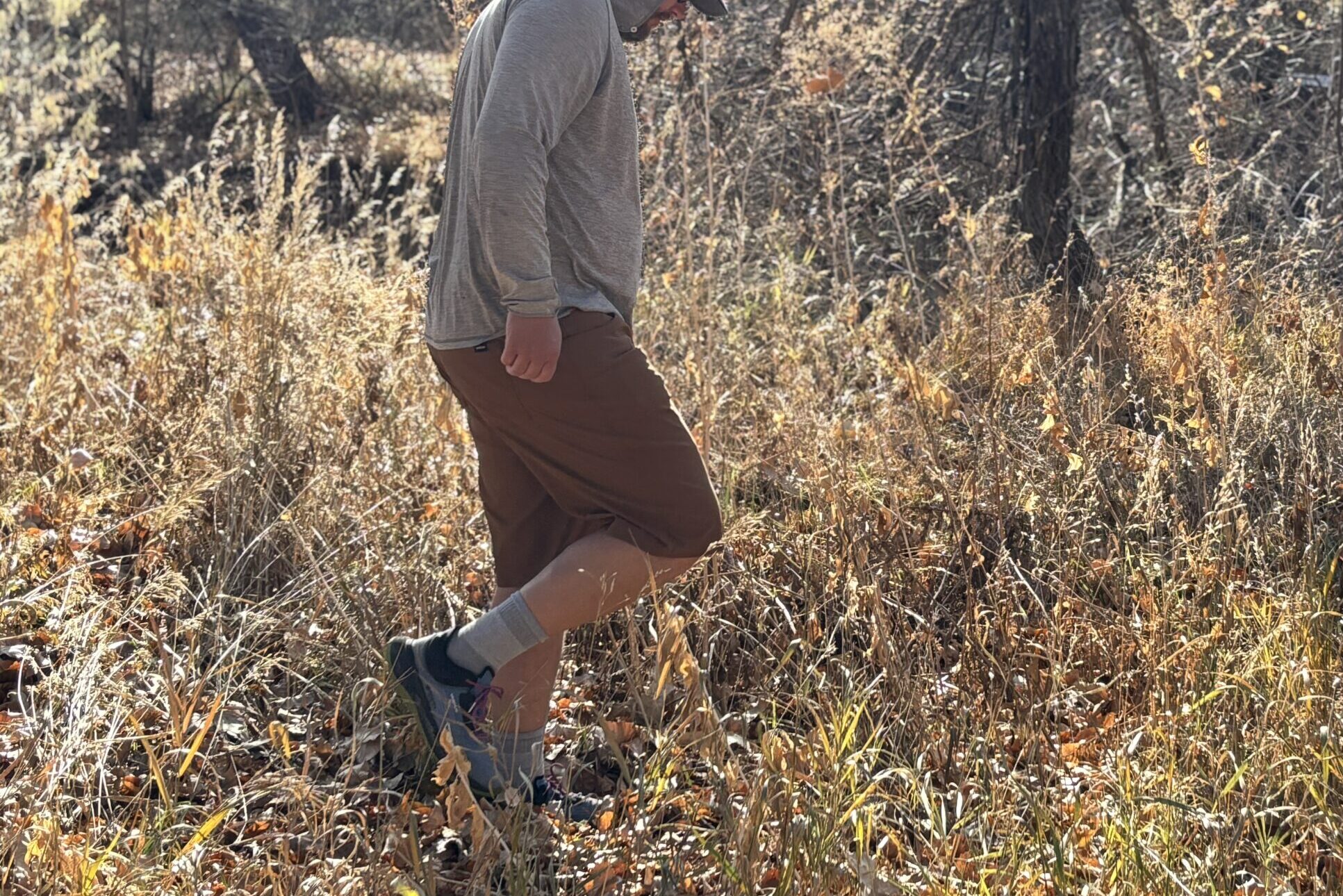 Man walking off trail in the woods.