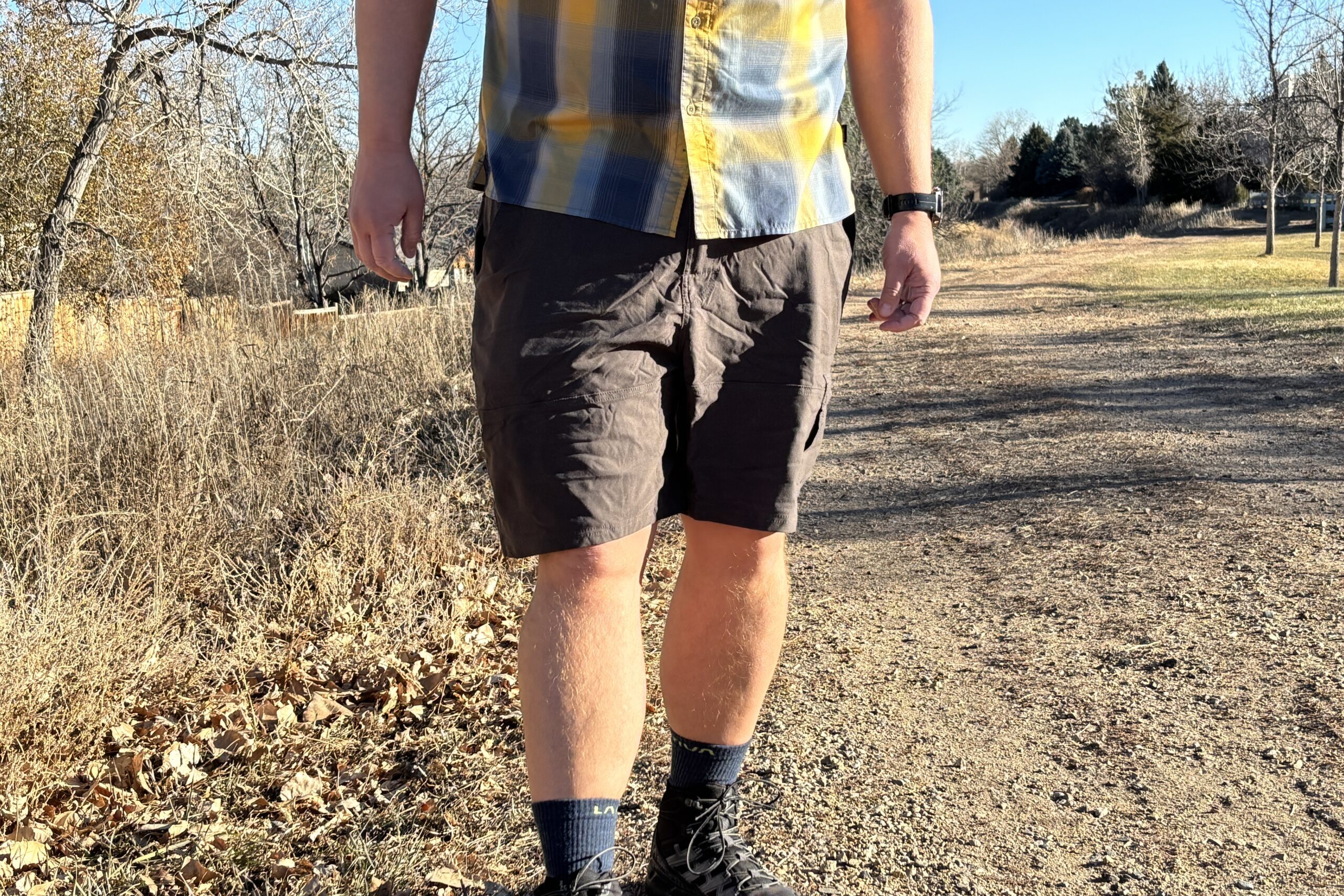 Man walking on trail in shorts.