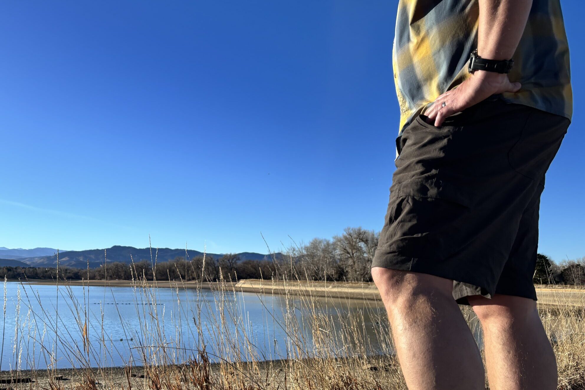 Man standing by a lake.