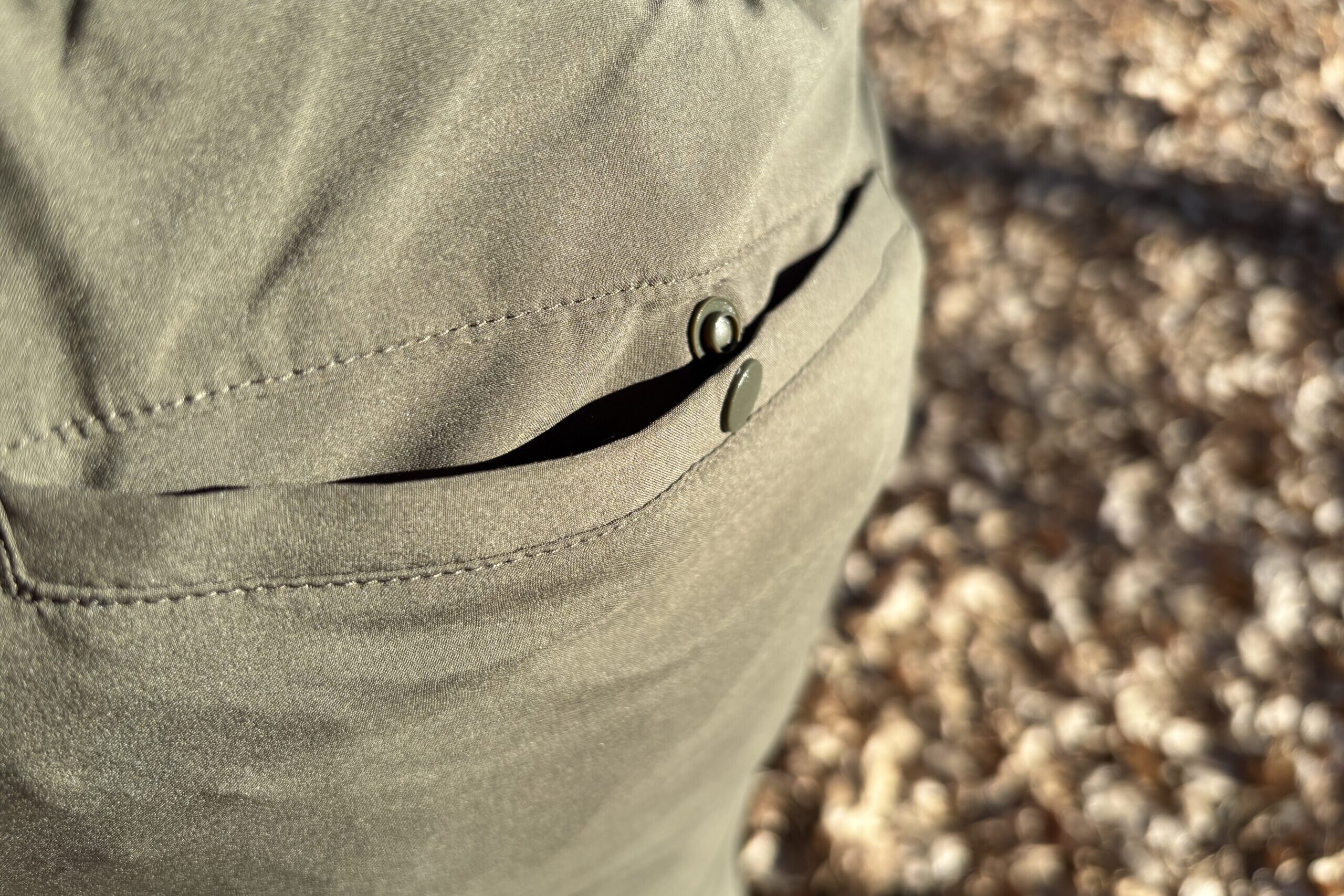 The button on the back pocket of a pair of shorts.