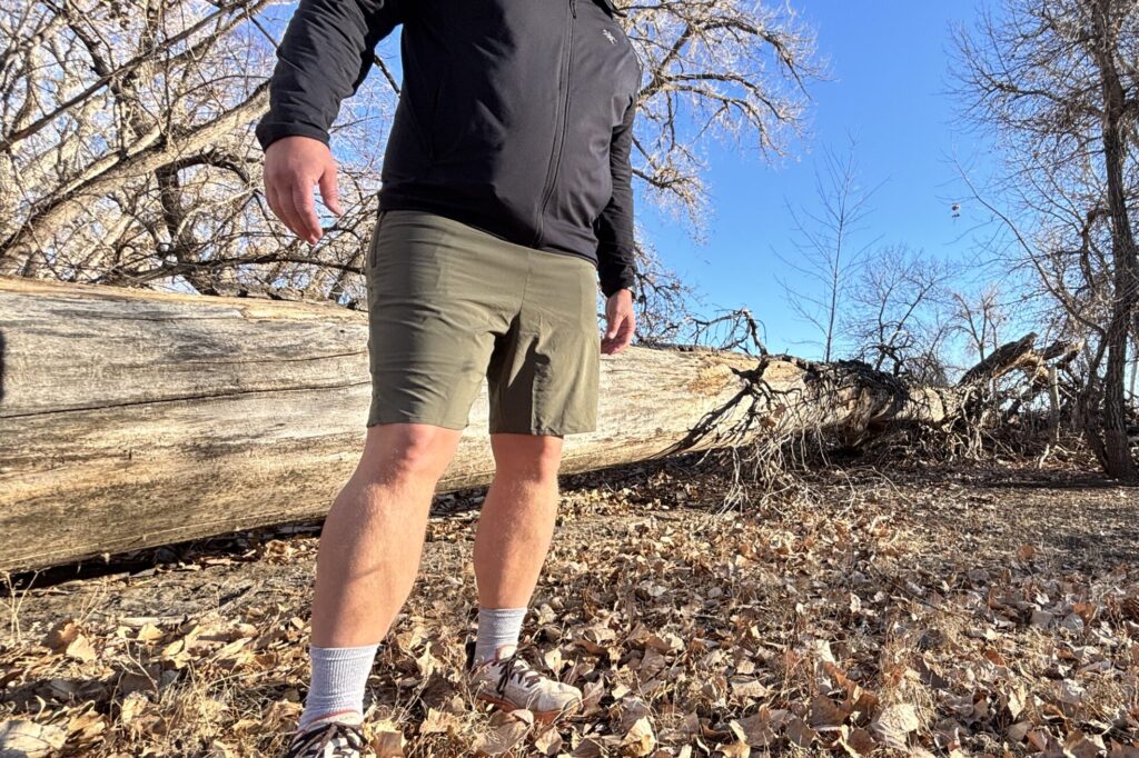 Man stands in a clearing in a forest.