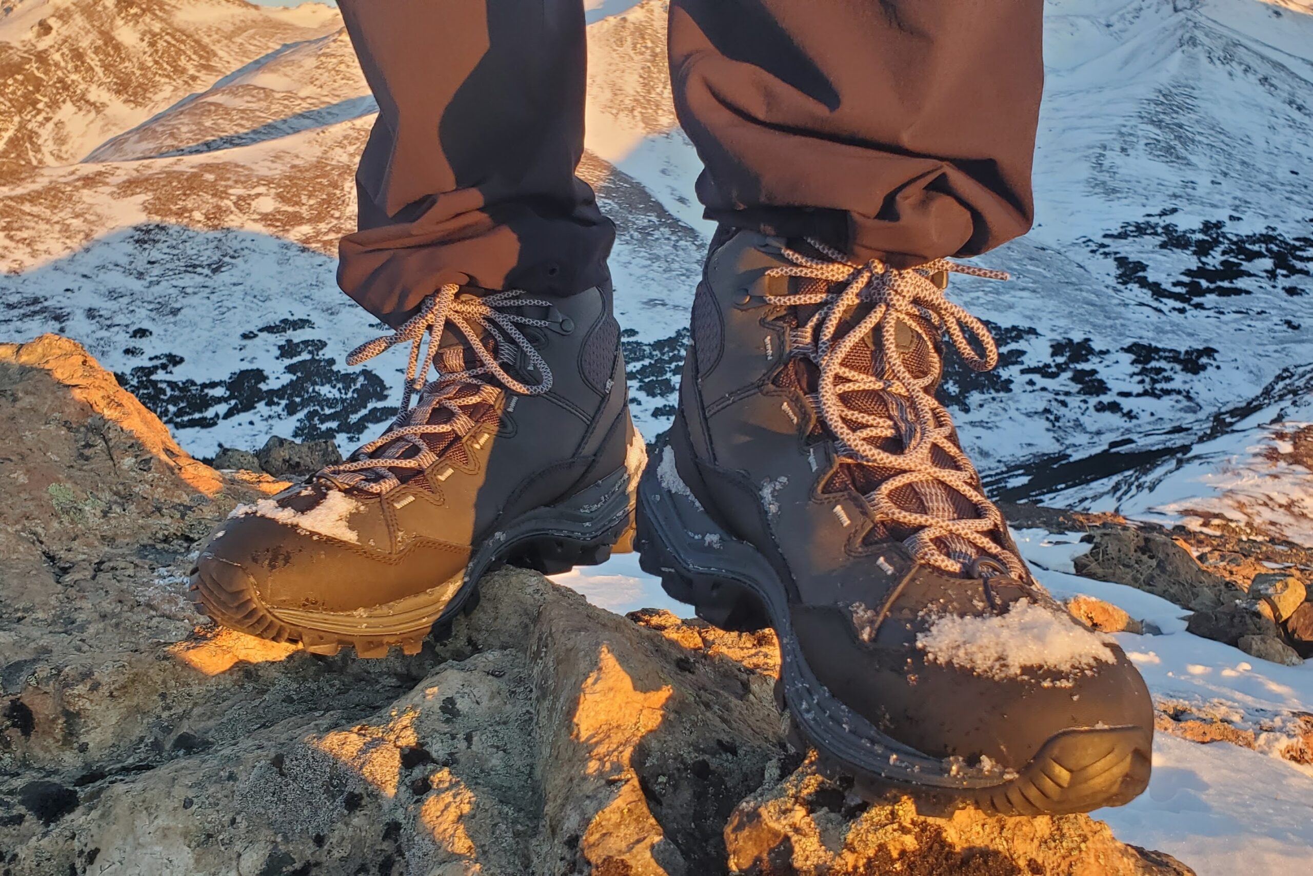 A closeup of snow covered boots.