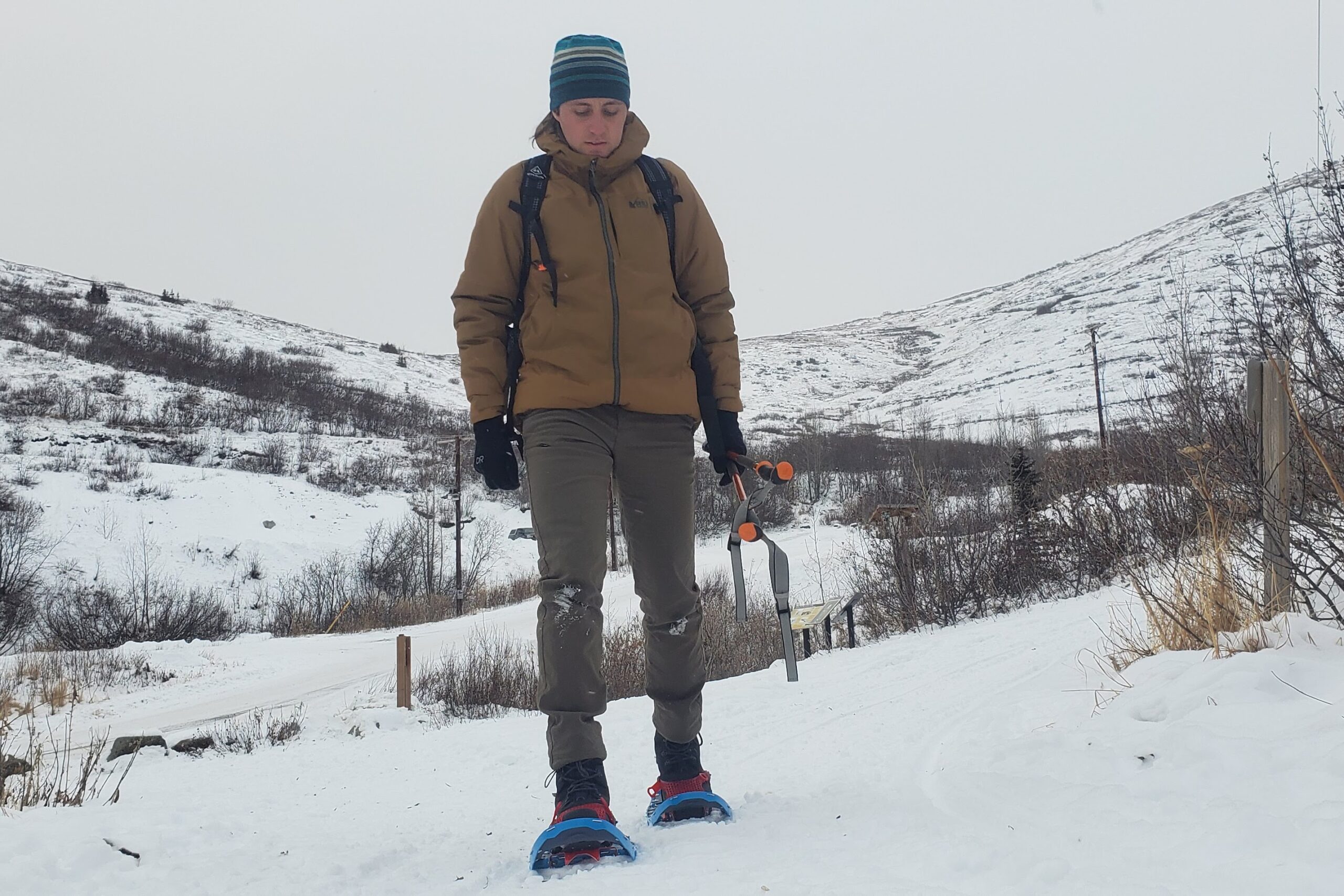 A closeup of a jacket worn on a man snowshoeing