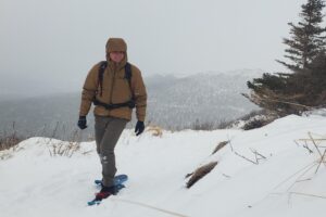 A man snowshoes through a blizzard