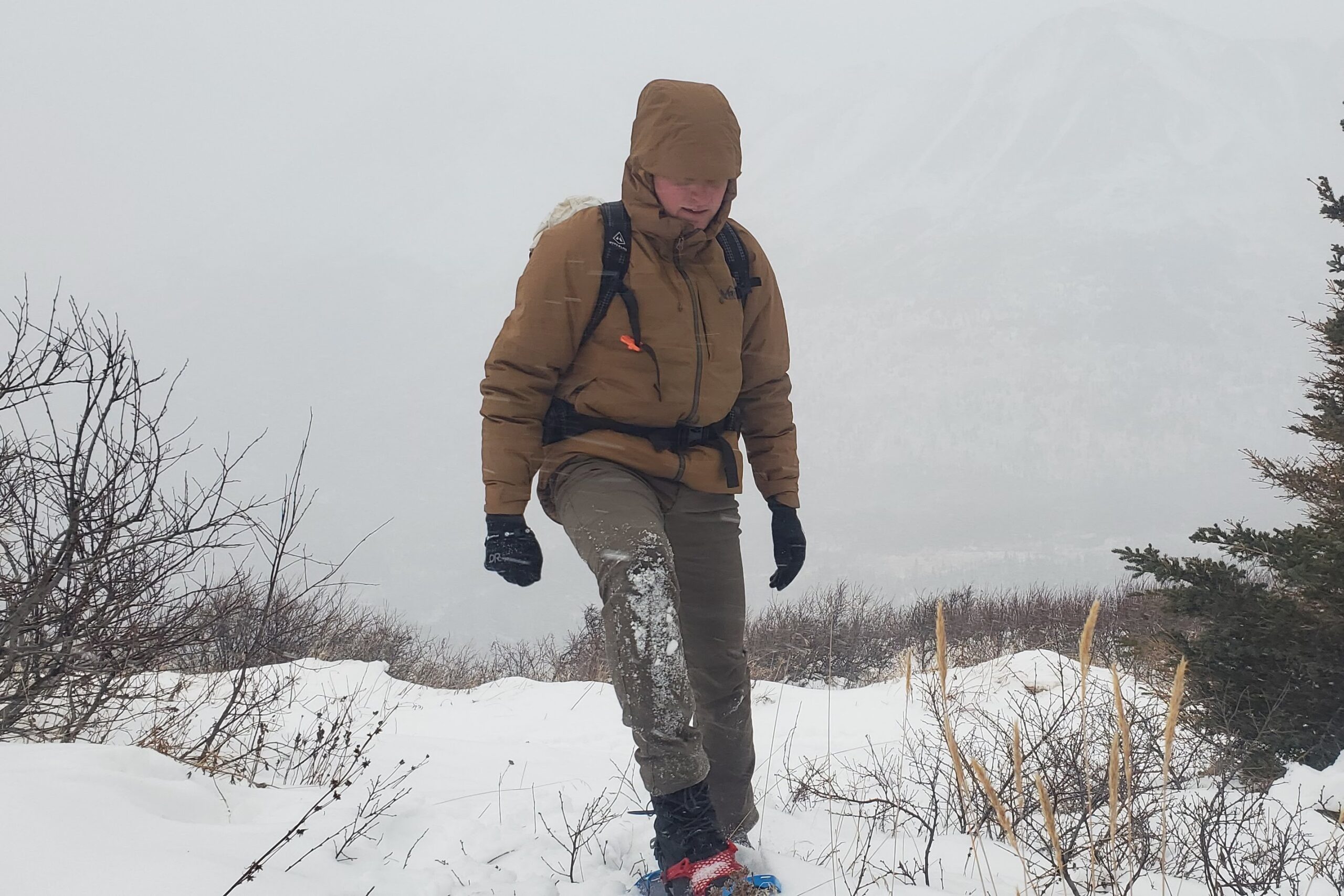 A man walks through deep snow in a blizzard.