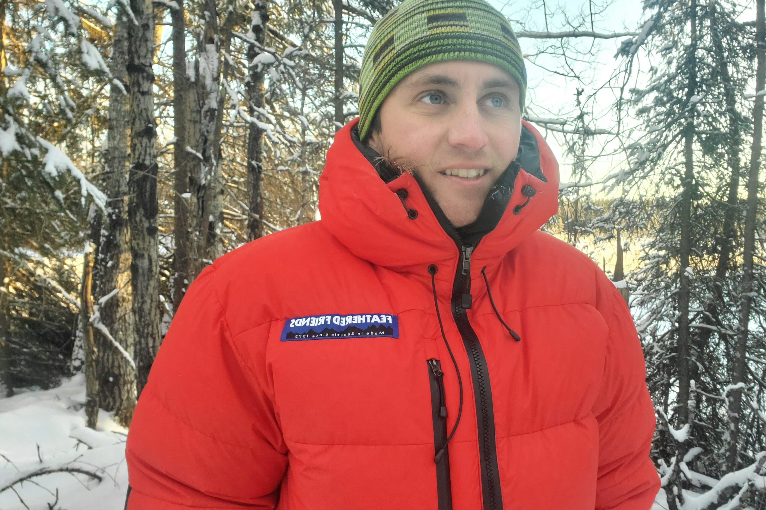 A closeup of the upper half of a red down jacket.