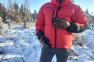 A closeup of gloves in front of a winter jacket.