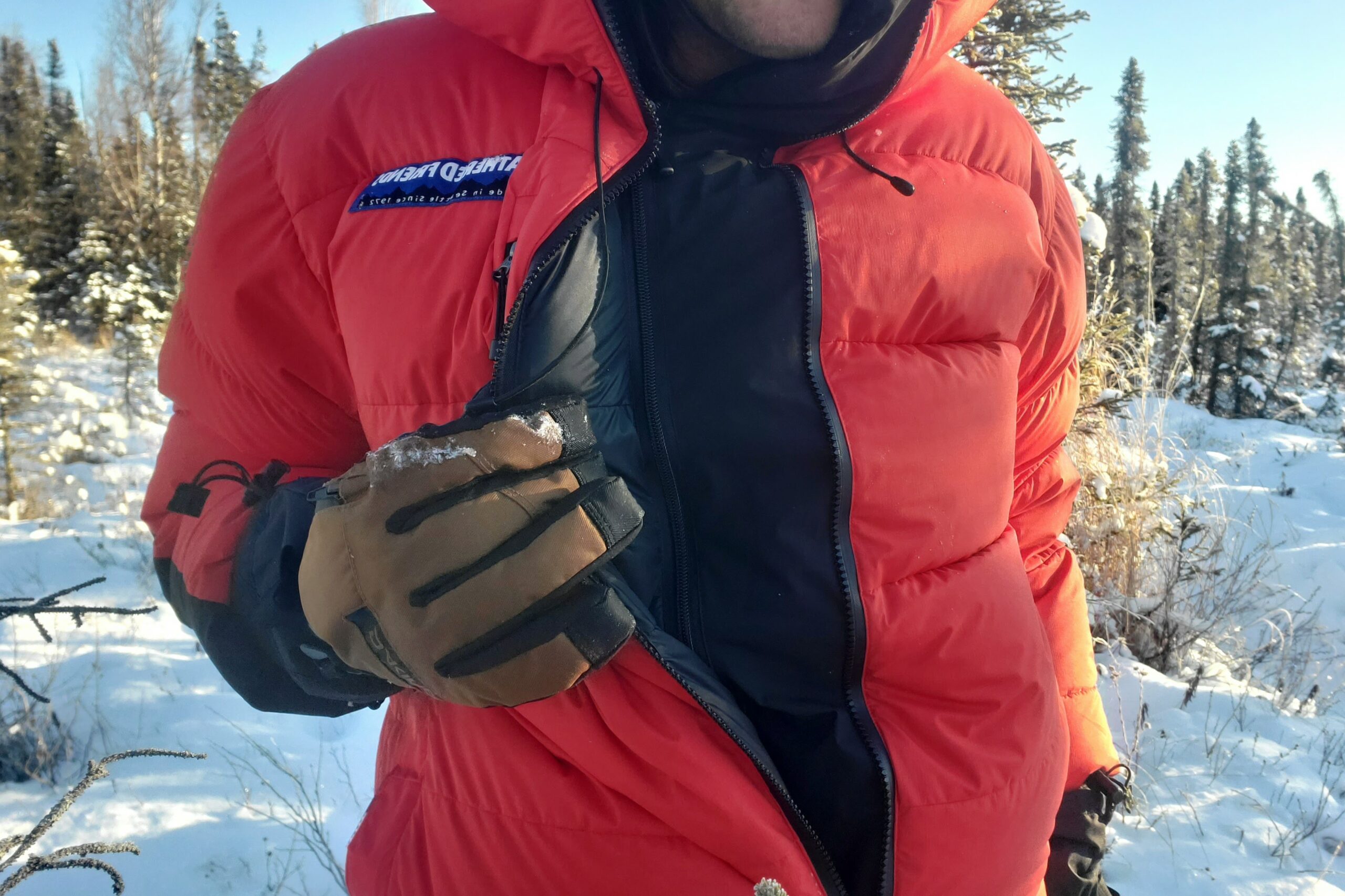 A man displays the zipped baffle of his parka