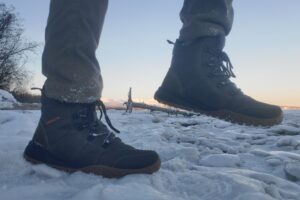 A closeup of the tread of shoes worn while walking.