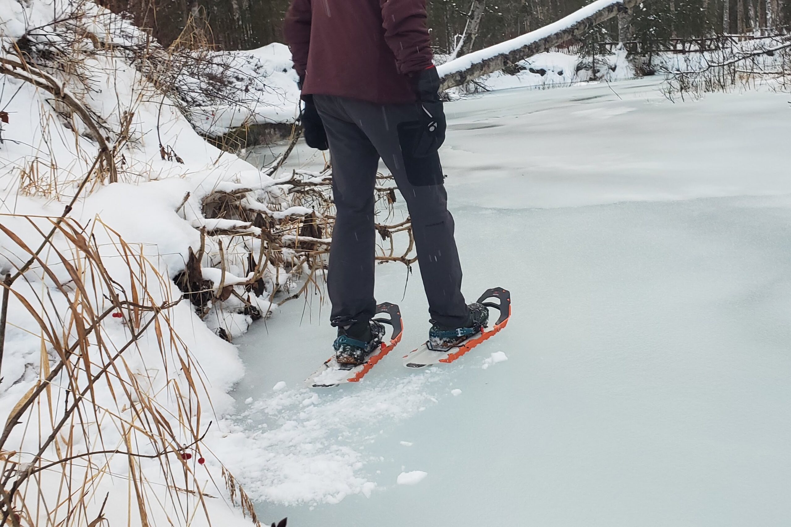 A man walks on ice in snowshoes