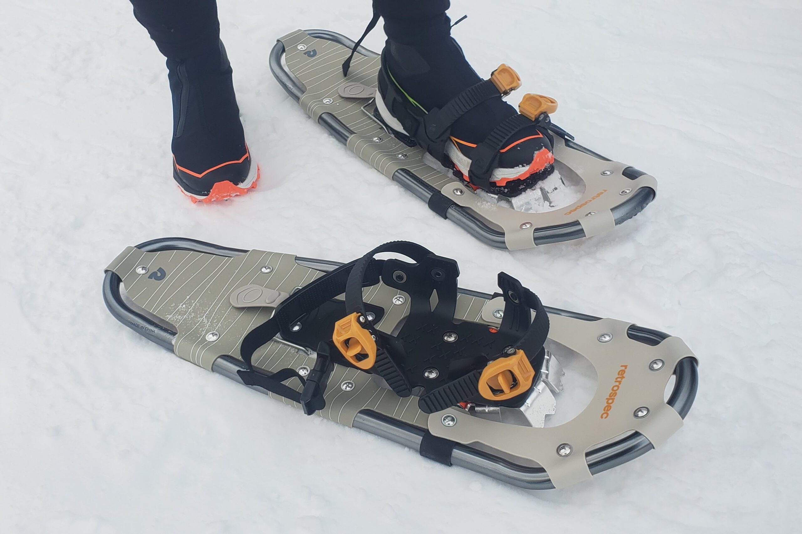 A detail shot of snowshoes on the ground.