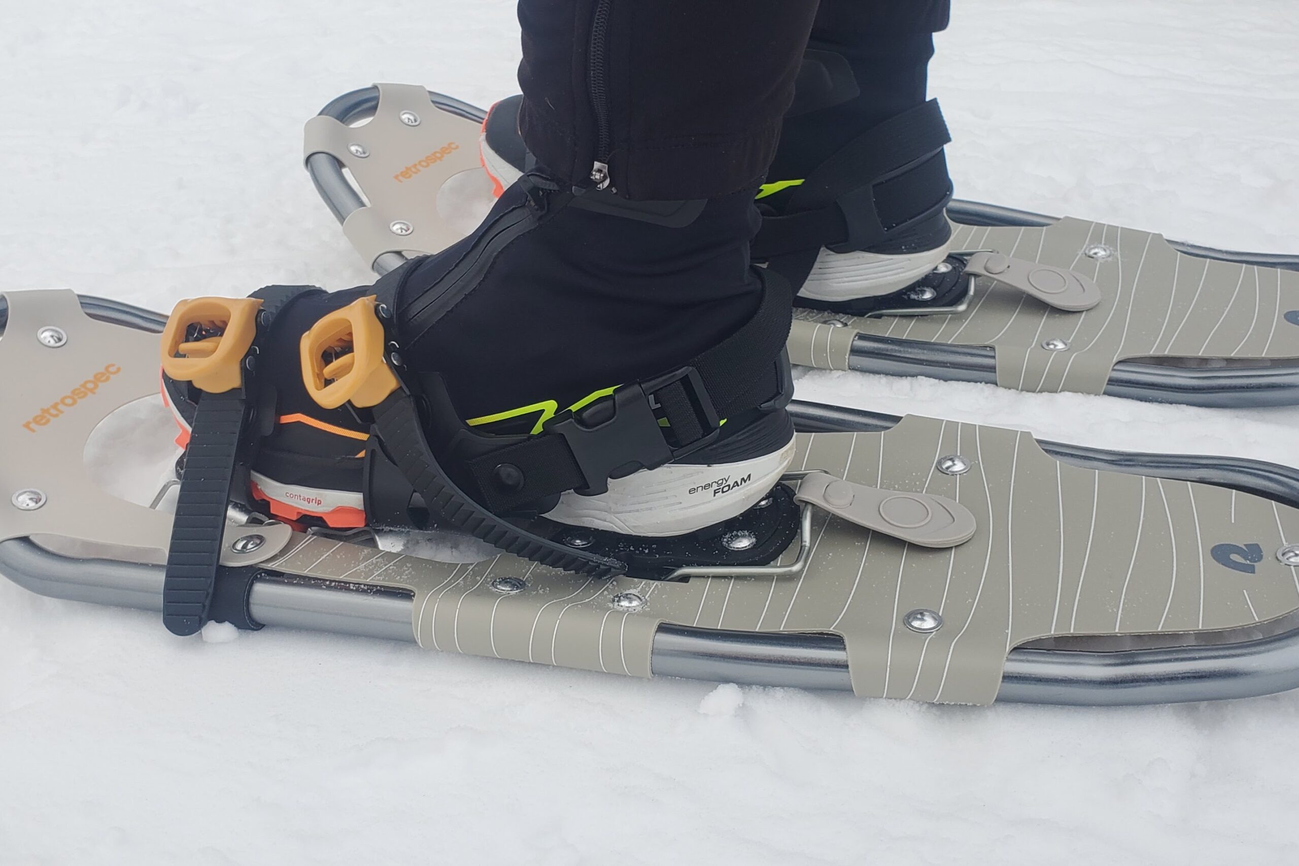 A closeup of the straps on a pair of snowshoes.