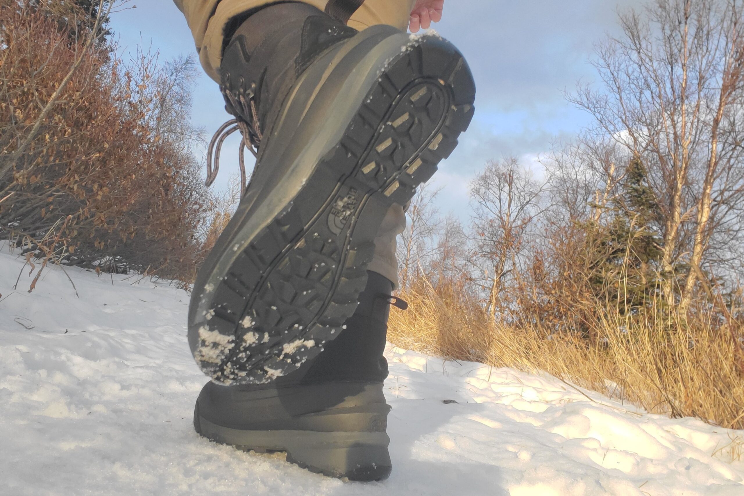 A closeup of the tread on a pair of winter boots