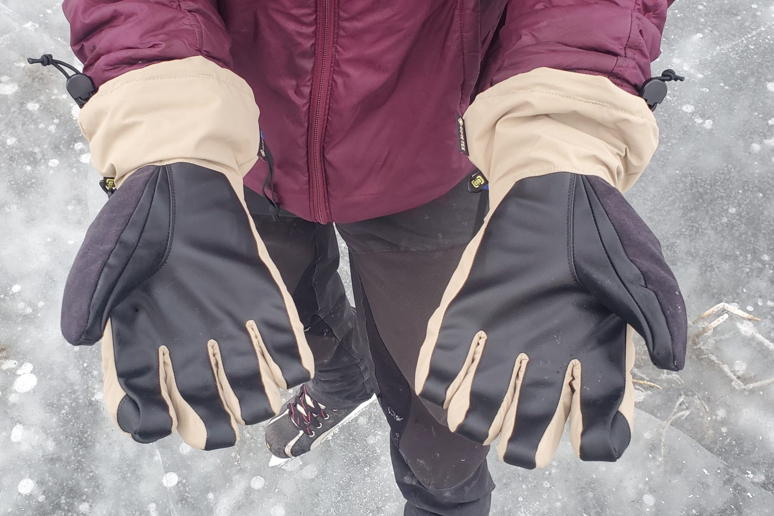 A man shows the palms of his gloves