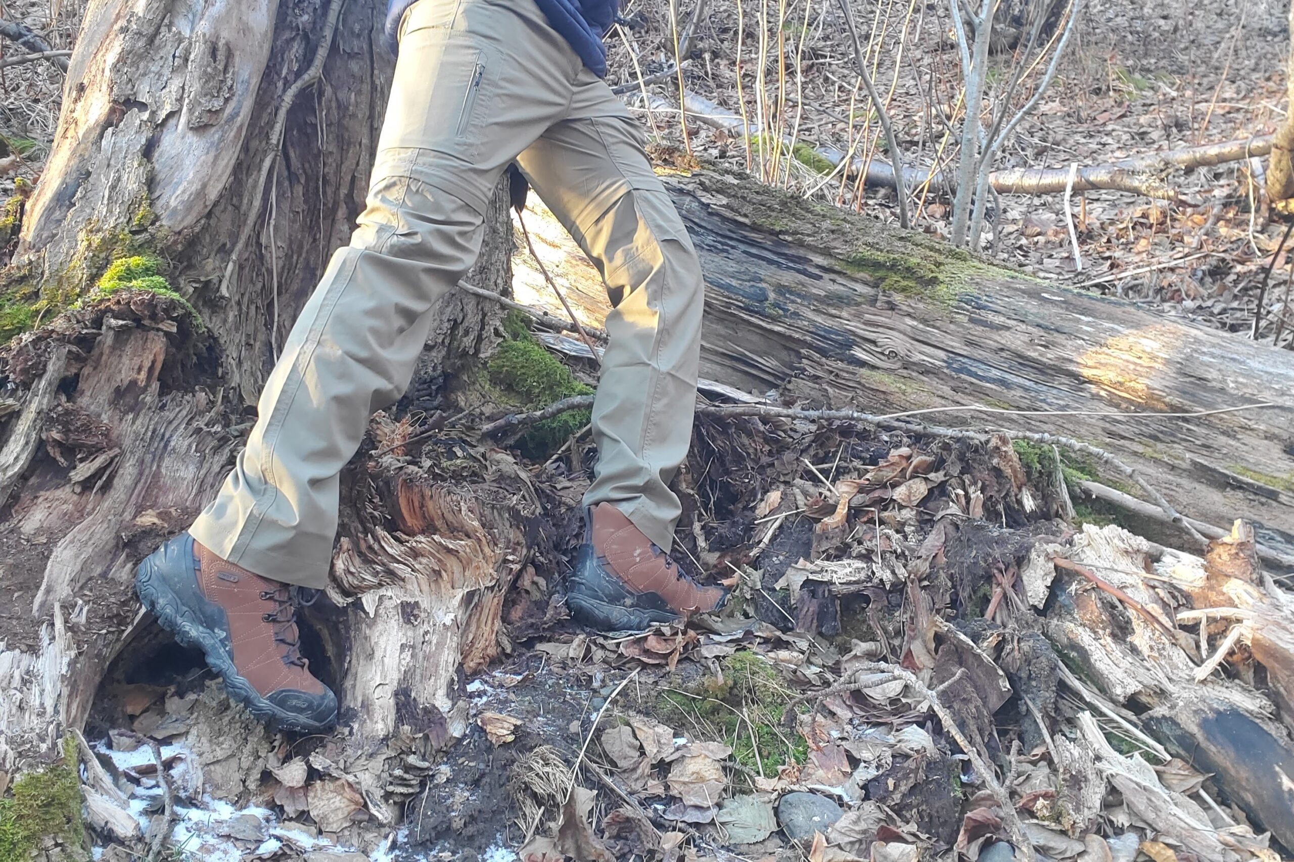 A closeup of boots walking off trail.