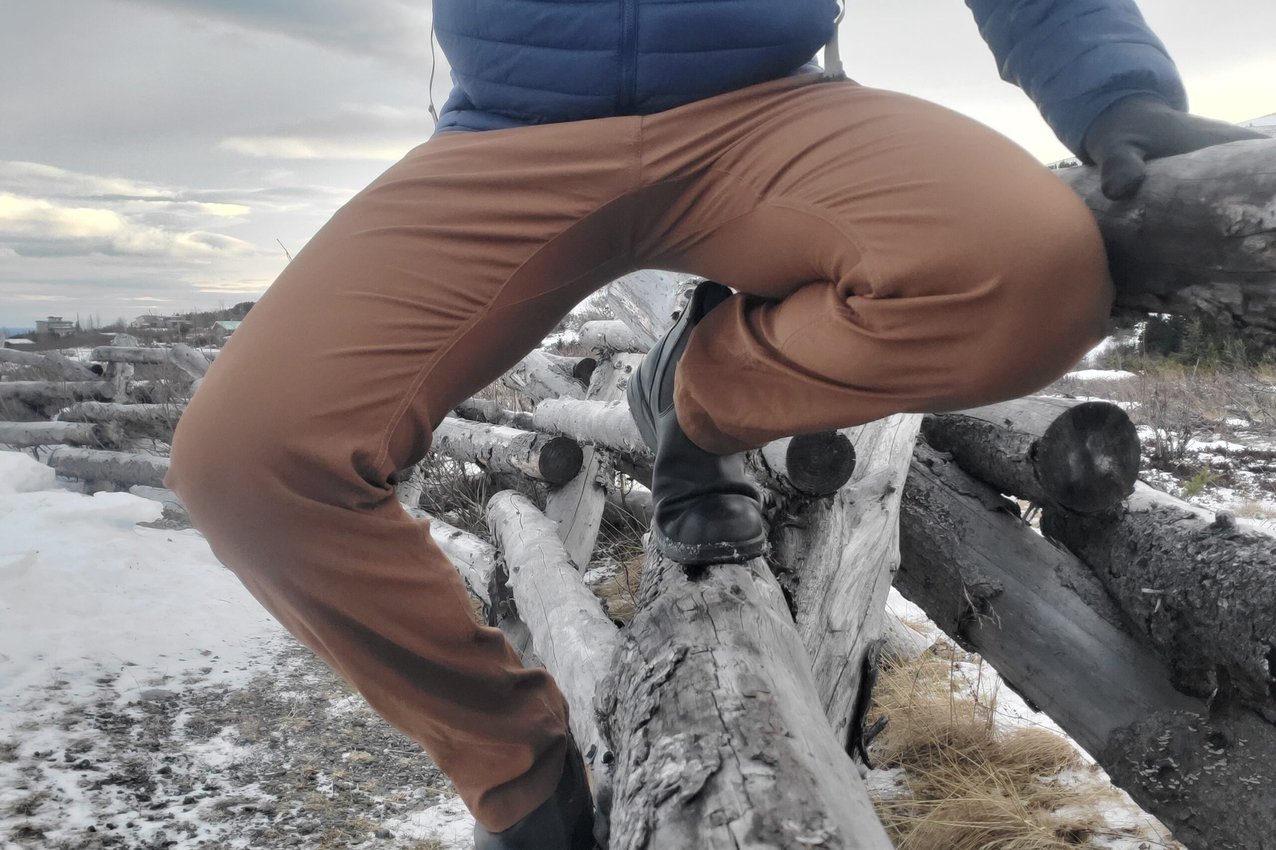 A closeup of a pair of pants as a man squats.