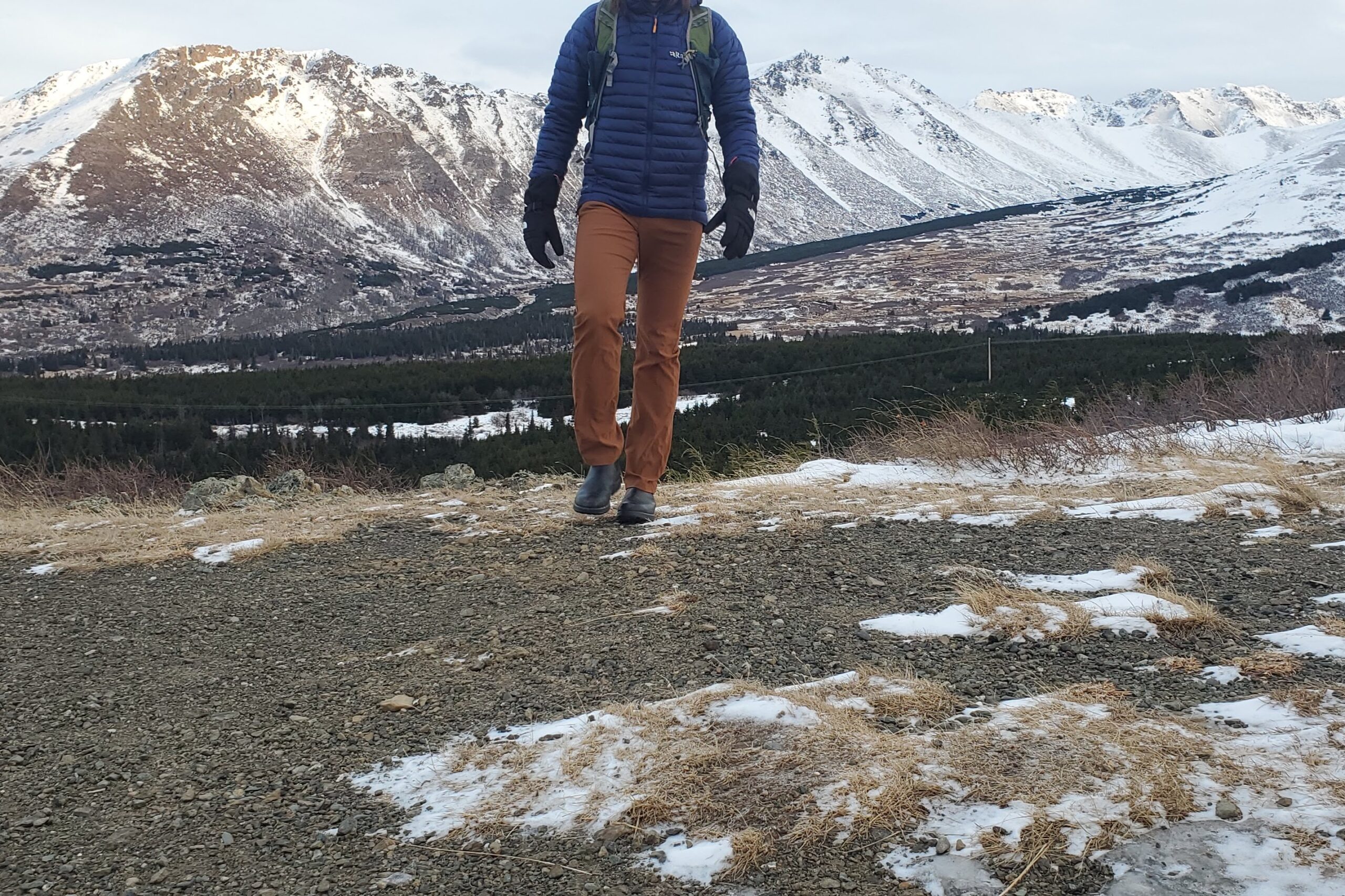 A man hiking with snowy mountain views.