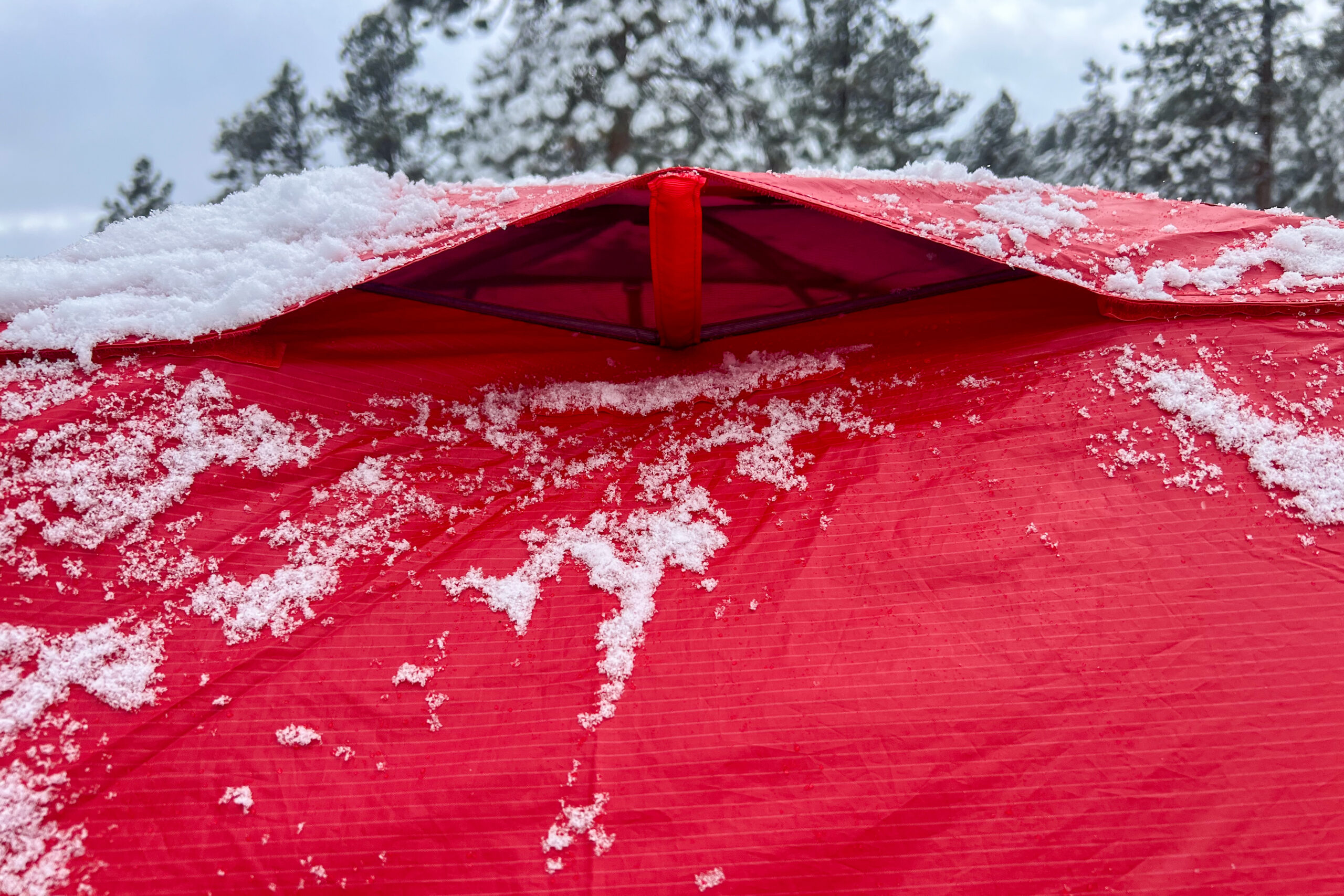 Close-up of the vented rainfly on the Big Agnes Copper Spur Expedition tent with snow on top.